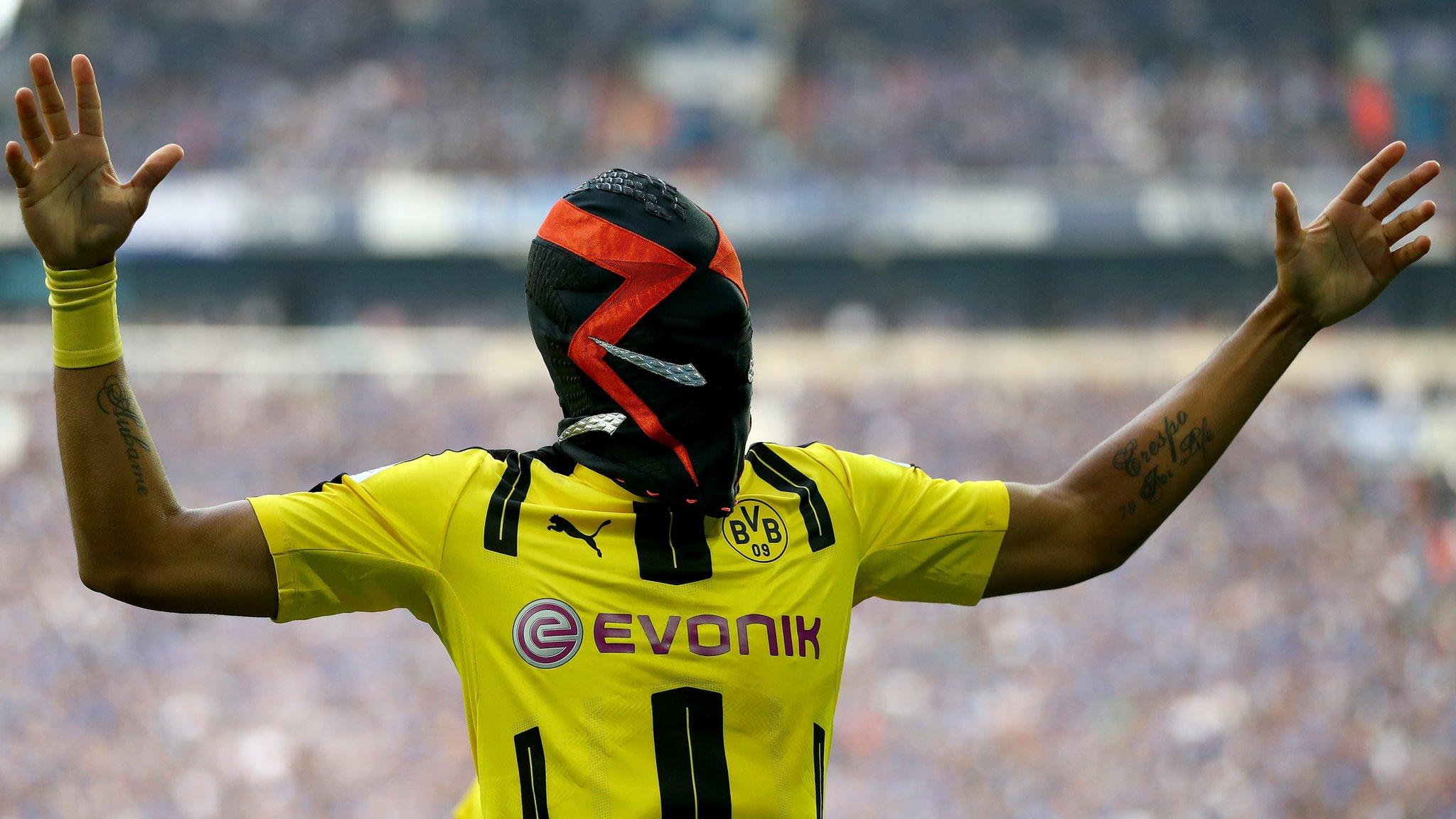 Borussia Dortmund striker Pierre Emerick Aubameyang celebrates scoring against Schalke by donning a mask