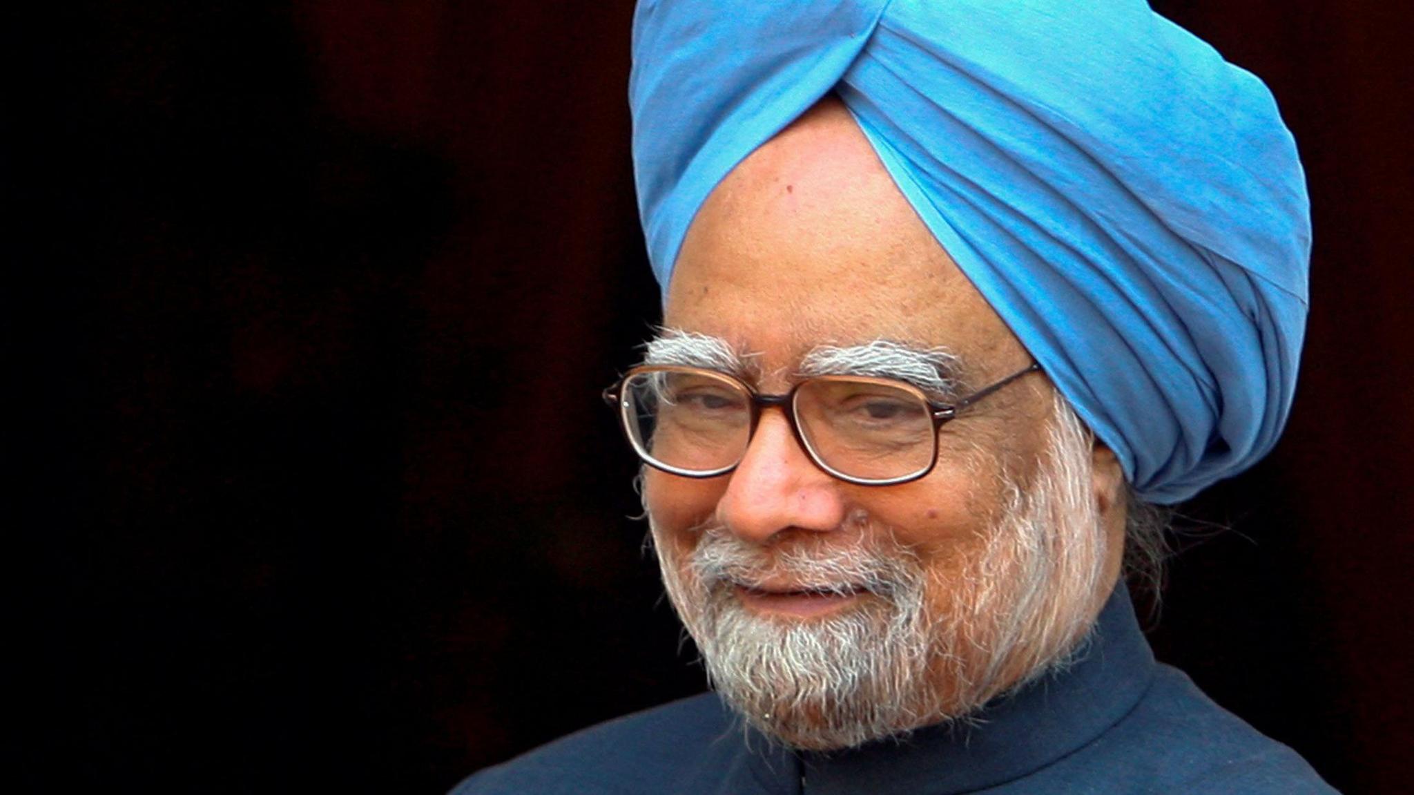 India's Prime Minister Manmohan Singh, wearing a navy blue suit, light blue turban and a pair of spectacles, smiles before a meeting with Russian President Dmitry Medvedev in New Delhi, India, December 5, 2008. 