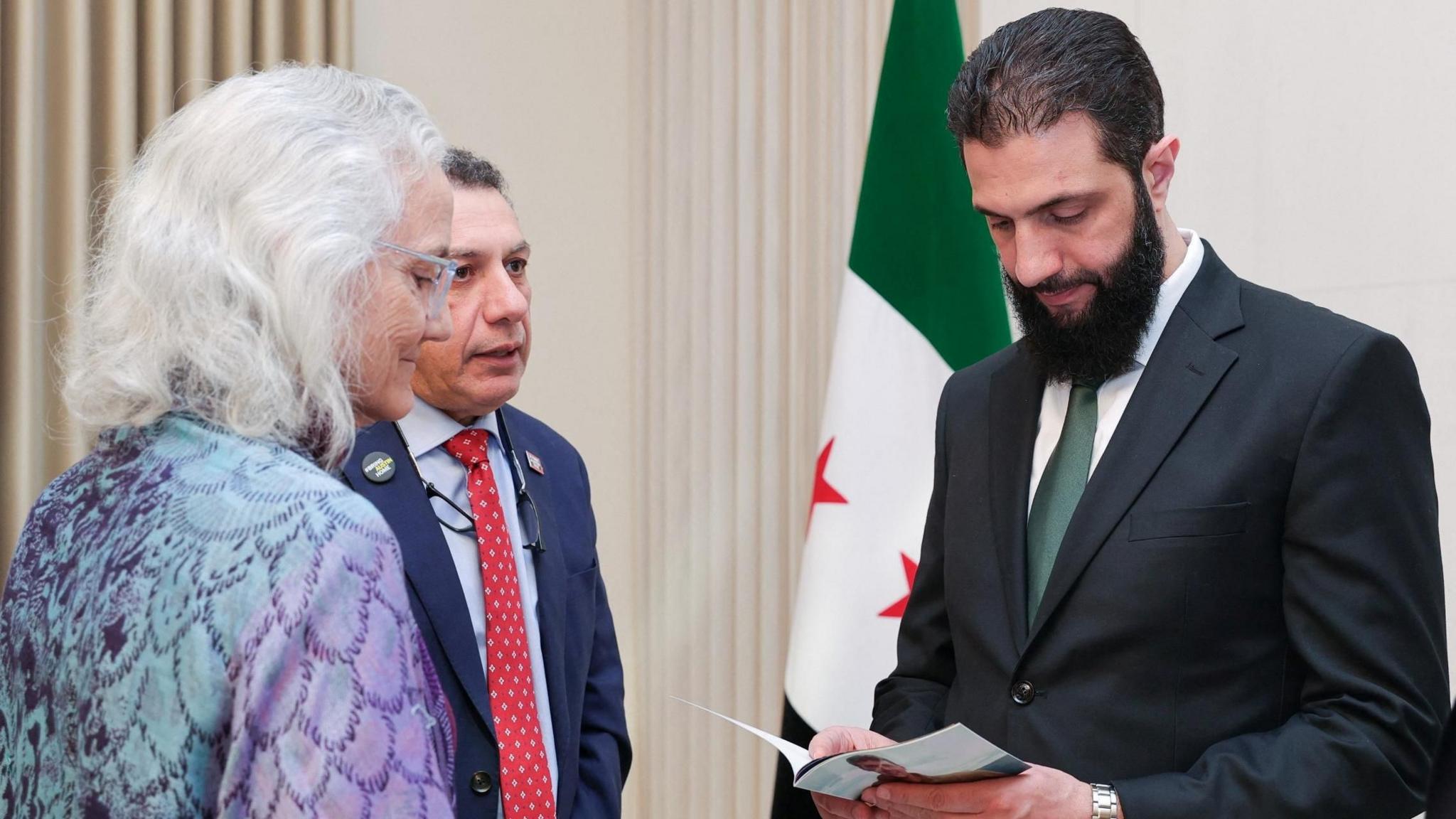 Debra Tice (L) and Nizar Zakka of Hostage Aid Worldwide (C) speak to Syria's de facto leader, Ahmed al-Sharaa (R), in Damascus, Syria (19 January 2025)