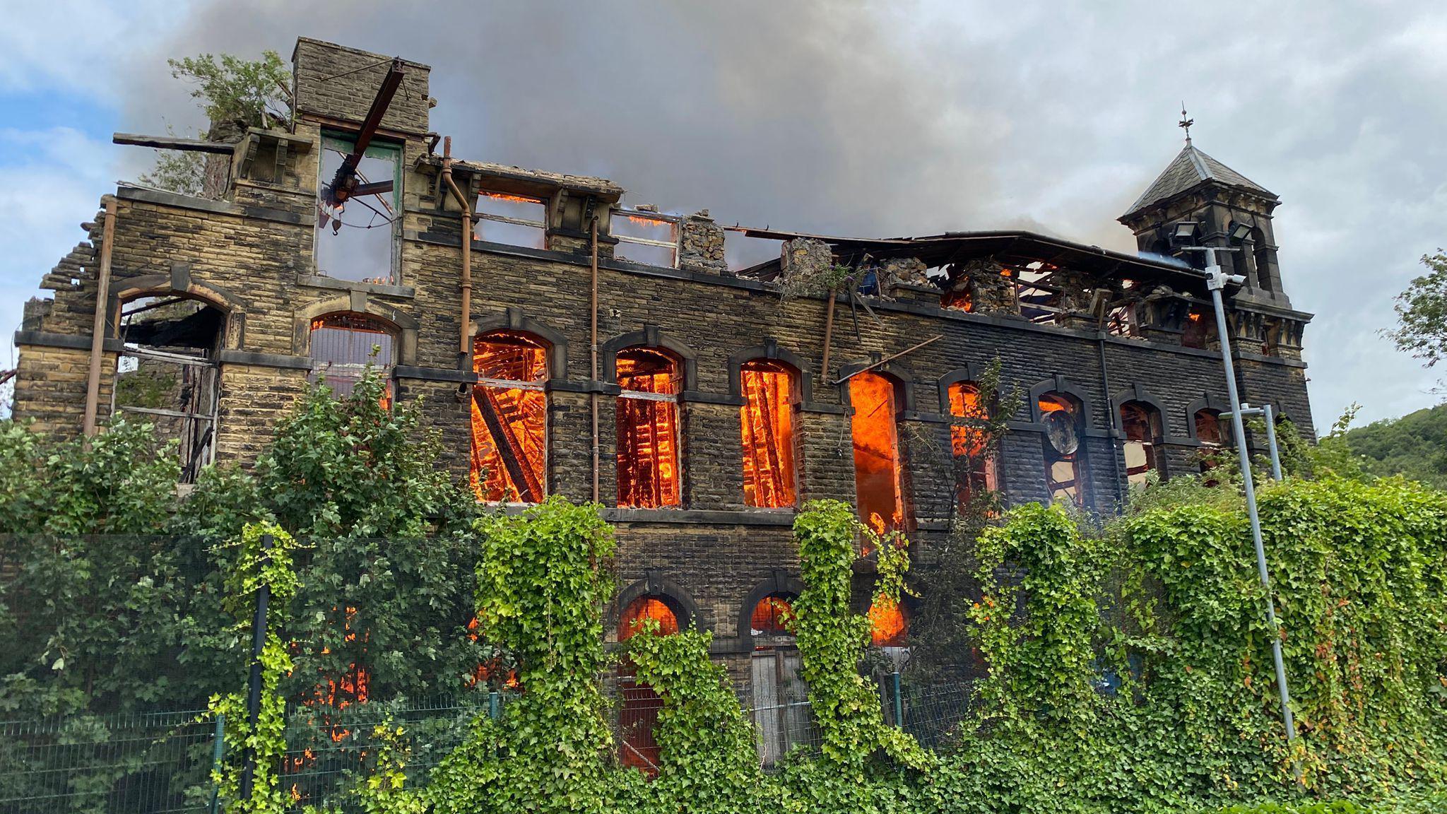 A derelict mill on fire