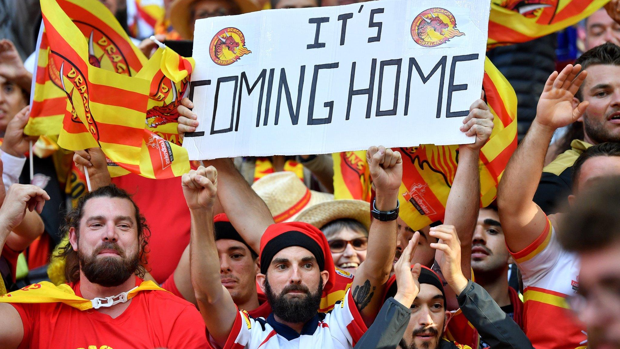 Catalans Dragons fans celebrate and hold up a sign that read 'It's coming home'