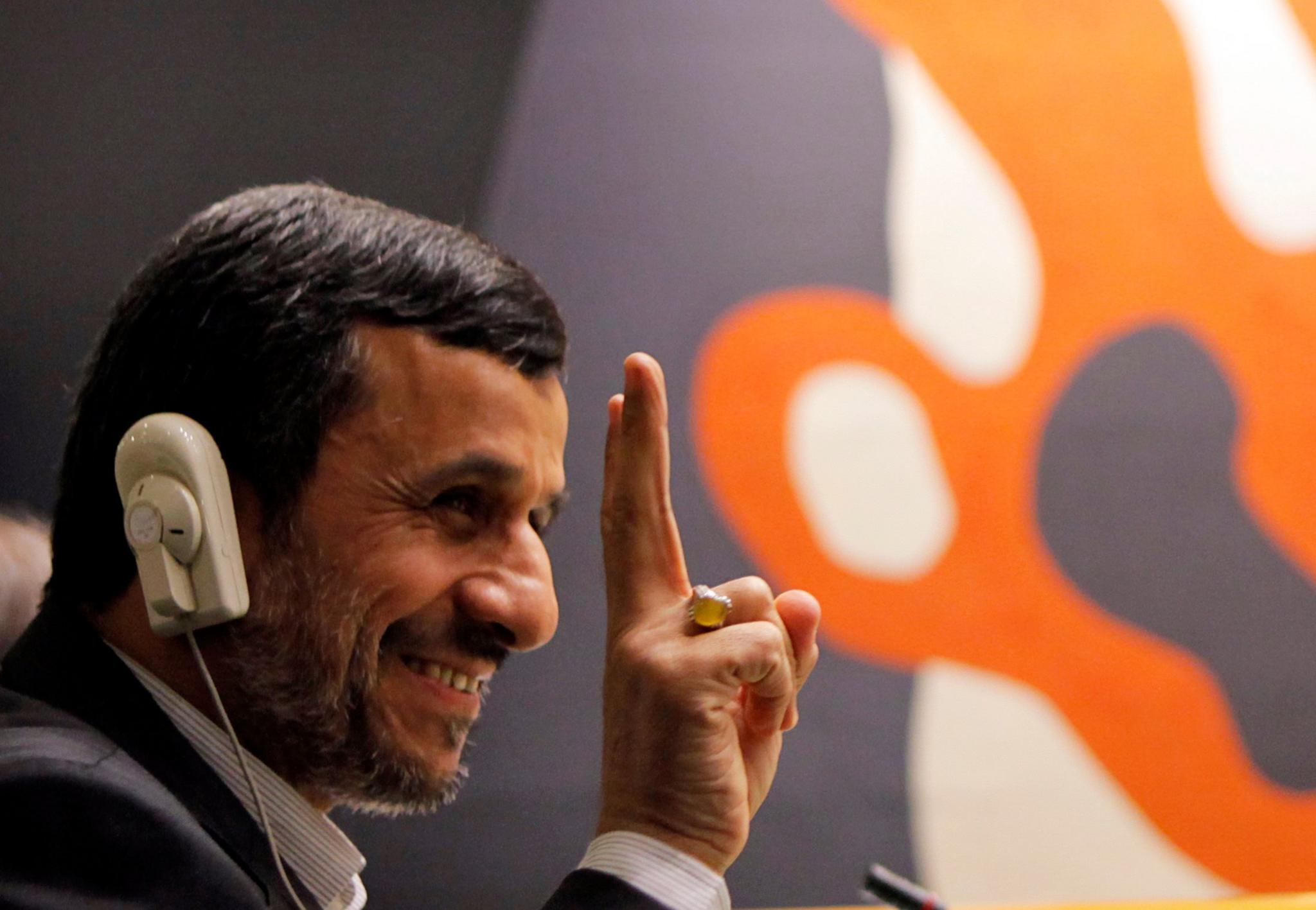 Former Iranian President Mahmoud Ahmedinejad flashes the peace sign during the high-level meeting of the General Assembly on the Rule of Law at the United Nations headquarters in New York September 24, 2012.