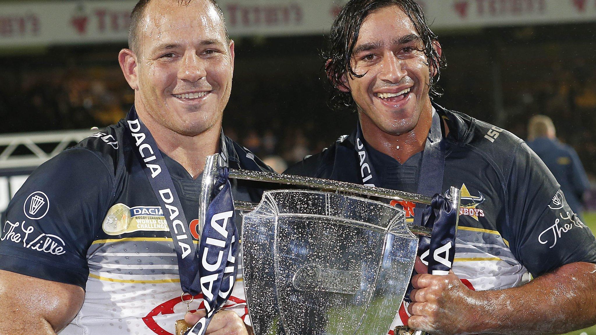 Matt Scott and Johnathan Thurston lift the World Club Challenge trophy