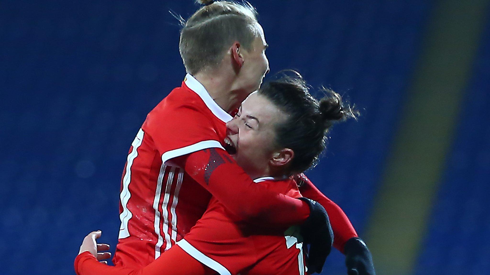 Jess Fishlock celebrates with Wales goal-scorer Hayley Ladd (R)