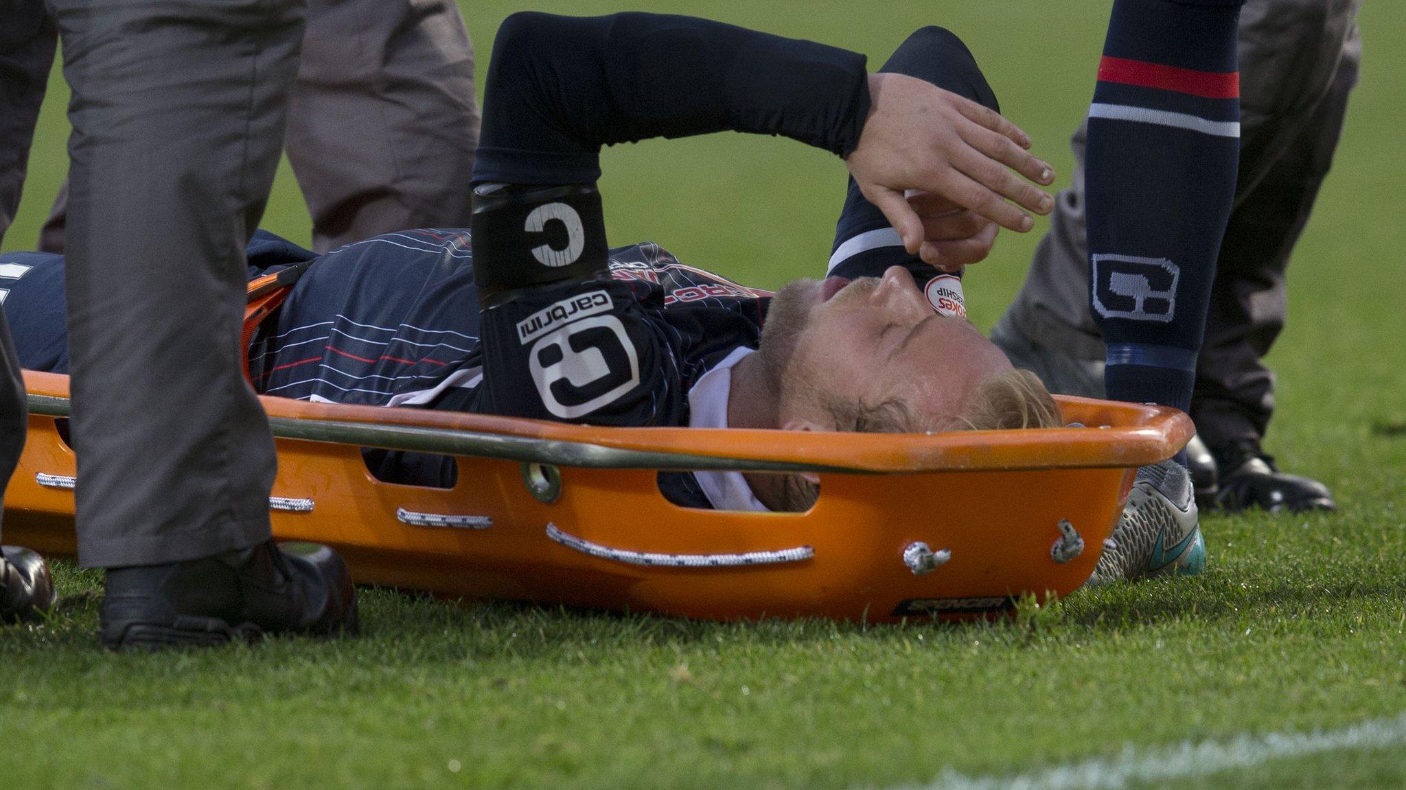 Ross County player Andrew Davies is stretchered off after receiving a head injury