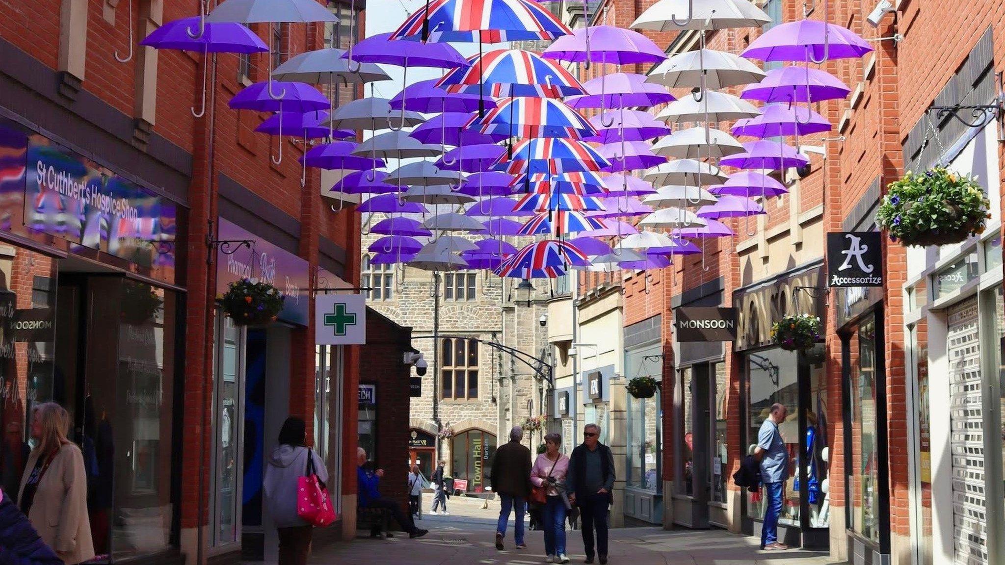 Umbrellas line the open roof of the shopping centre