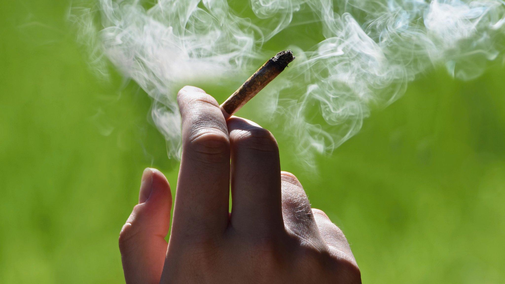 man holding a cannabis joint