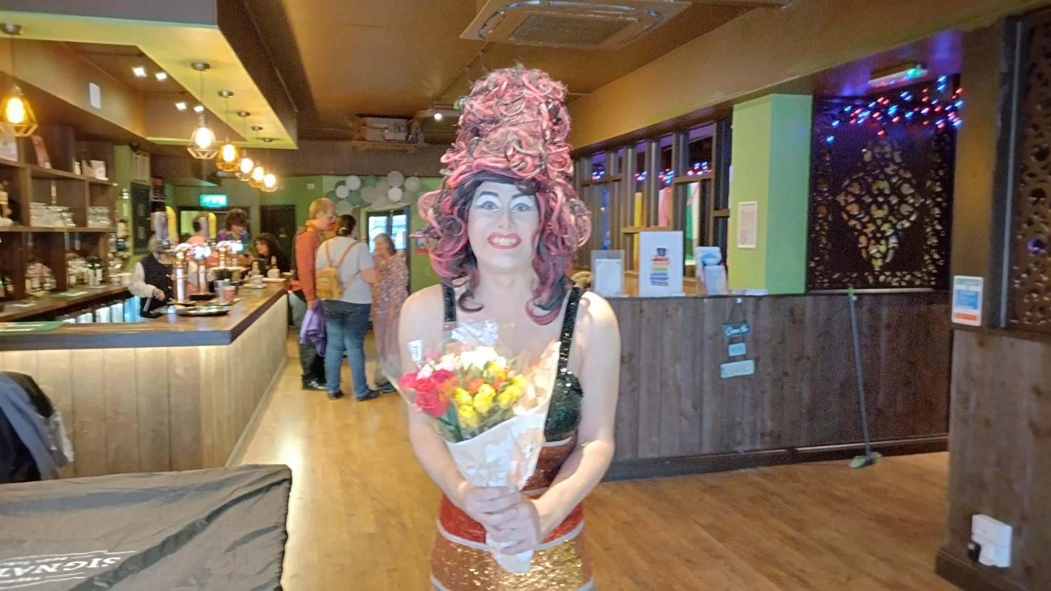 Aida H Dee holding flowers after her performance