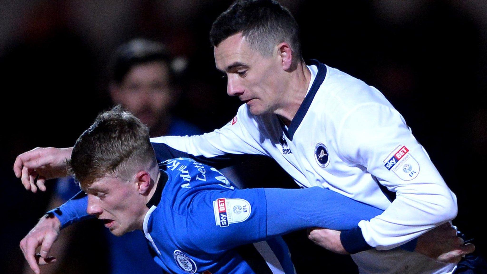 Andrew Cannon of Rochdale is challenged by Shaun Williams of Millwall