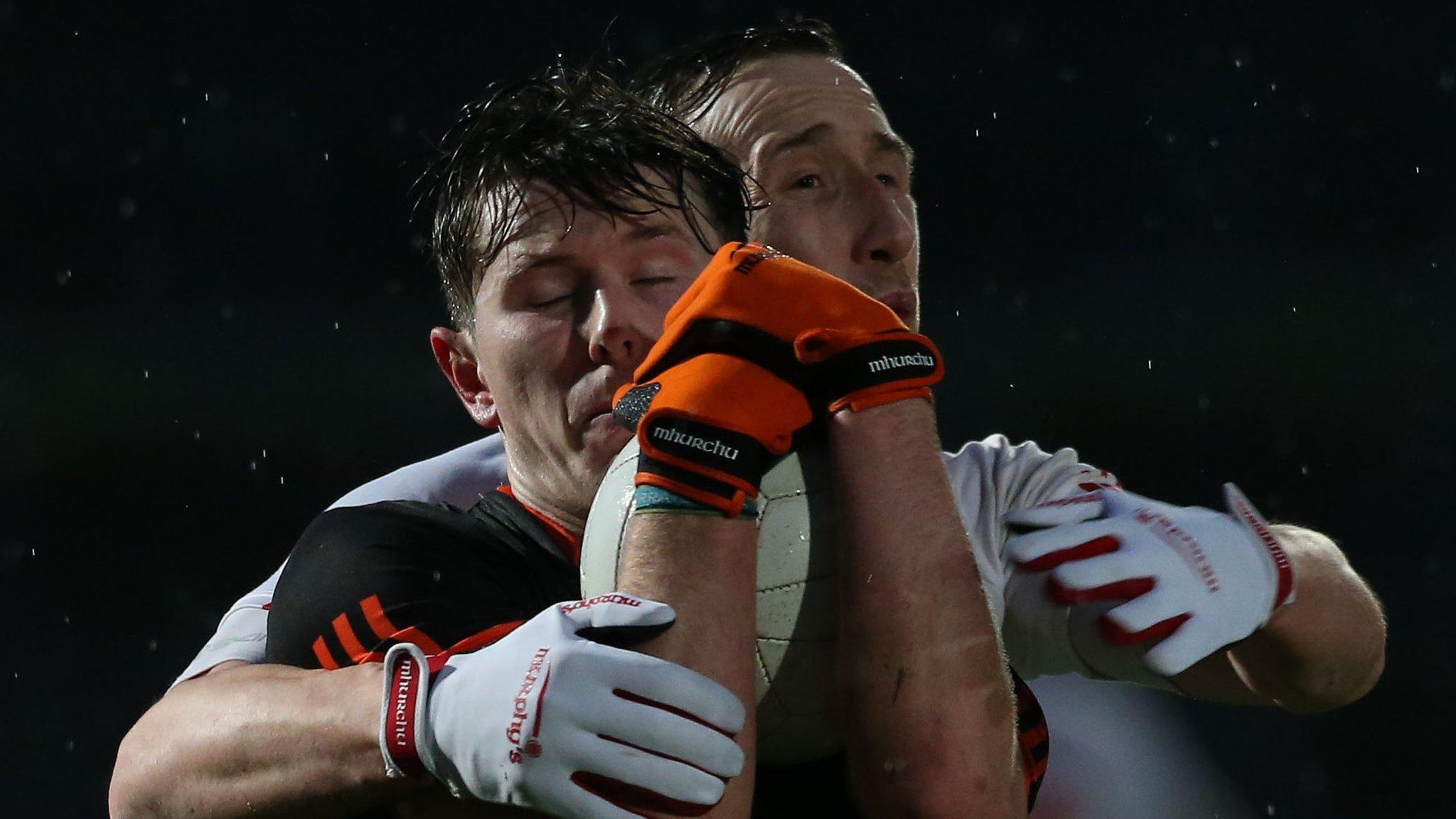 Armagh's Joe McElroy is tackled by Tyrone's Colm Cavanagh