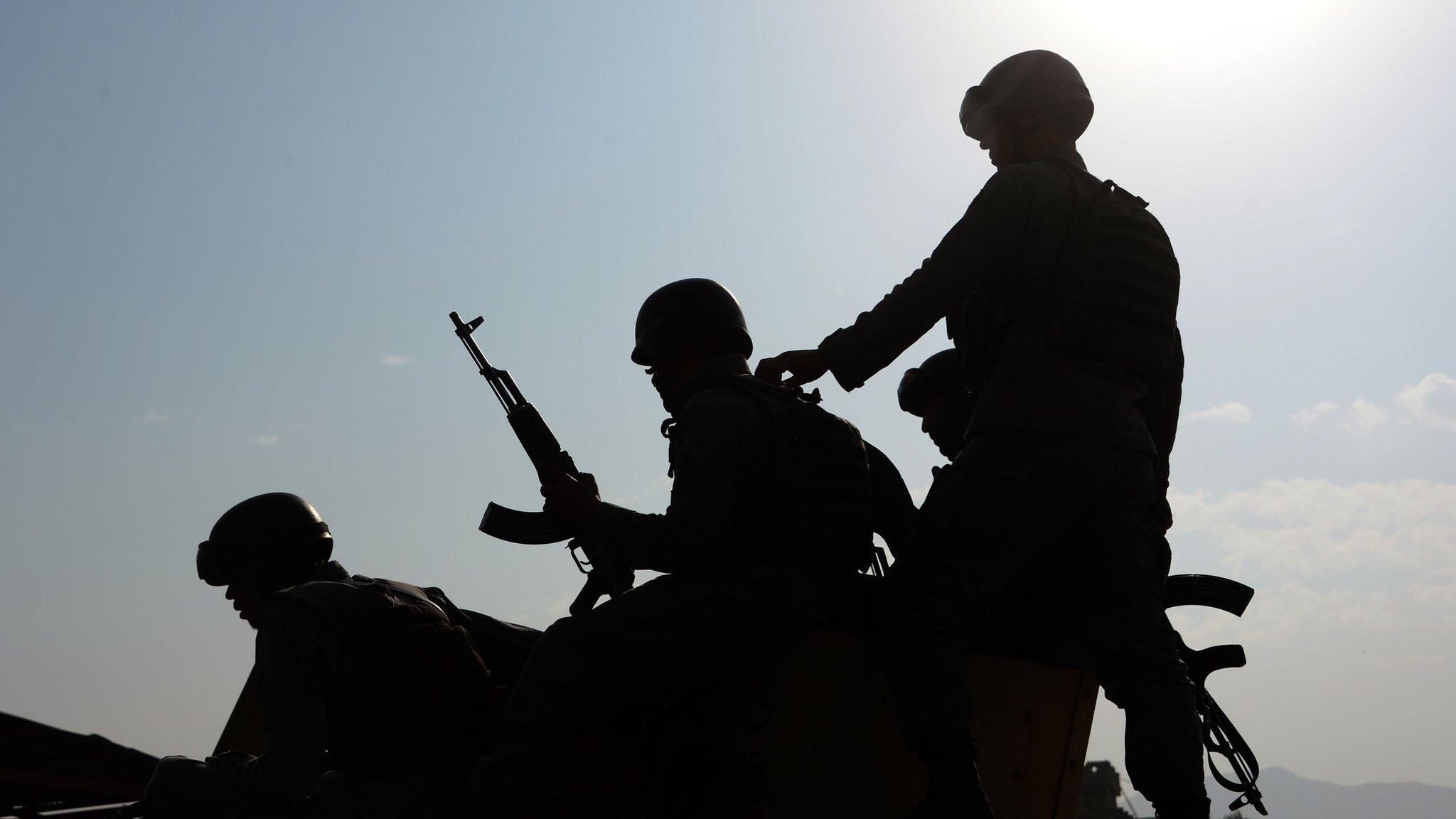 Afghan security personnel on a military vehicle at the site of an attack by Taliban militants in Kabul on October 6, 2015.