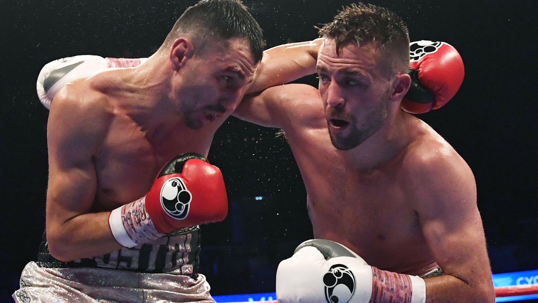 Josh Taylor (right) unleashes a punch against Viktor Postol