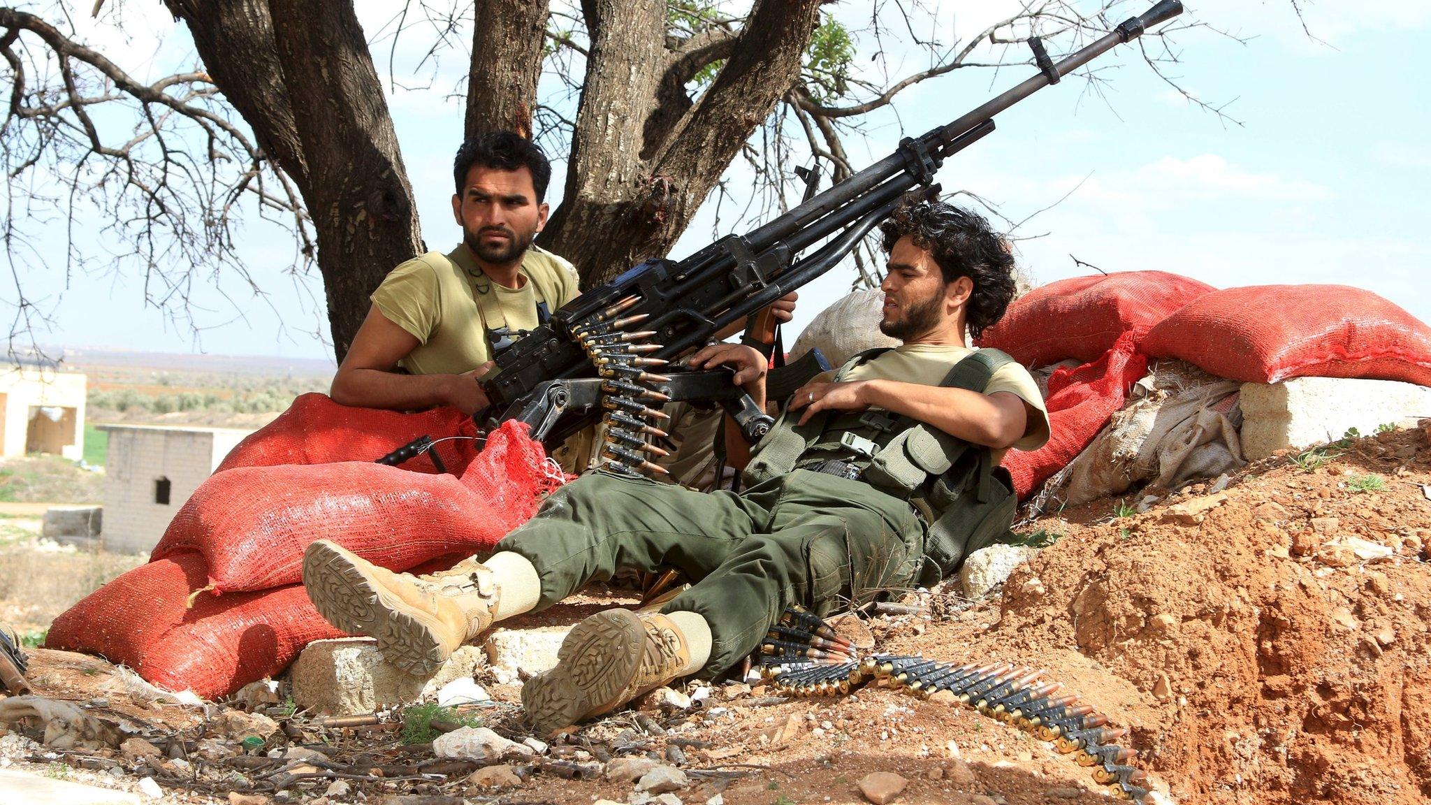 Rebel fighters rest with their weapons in Latamina village, northern Hama countryside (5 March 2016)