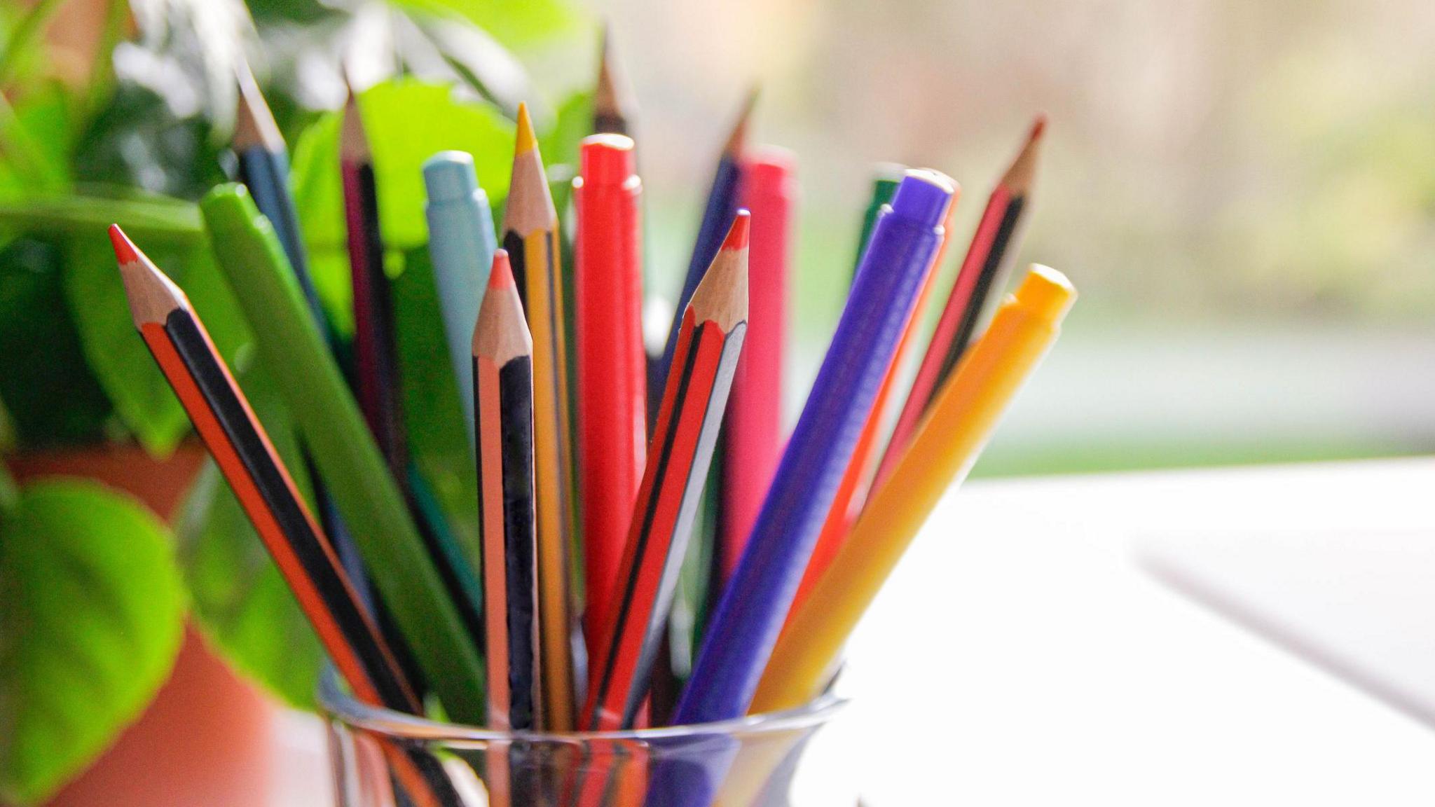 A glass pot of pencils.