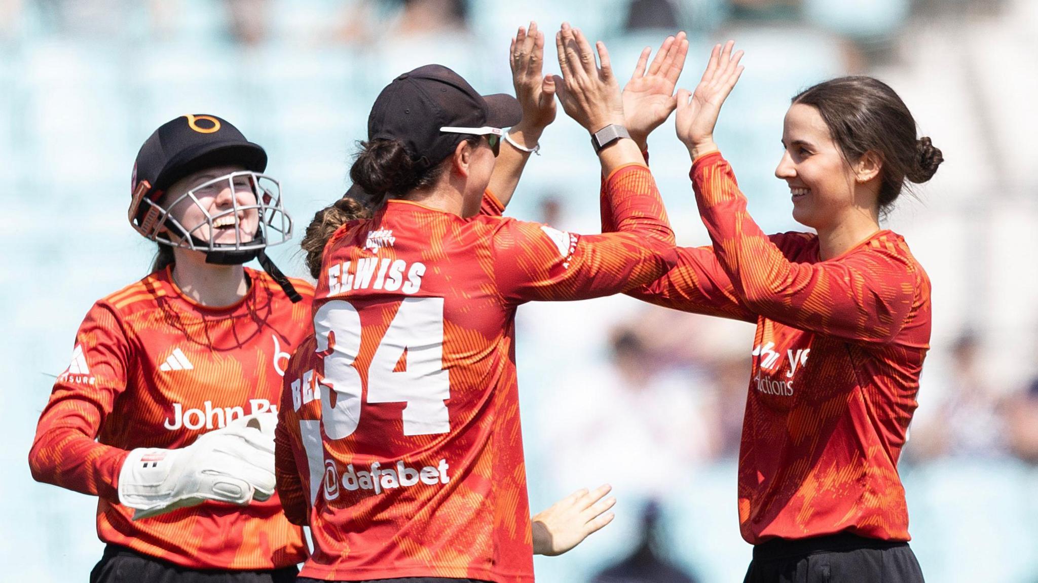 Charli Knott (right) is congratulated by Blaze team-mate Georgia Elwiss (wearing the number 34) after taking a wicket against Surrey in the Vitality Women's Blast semi-final at The Oval on Friday 17 July, 2026