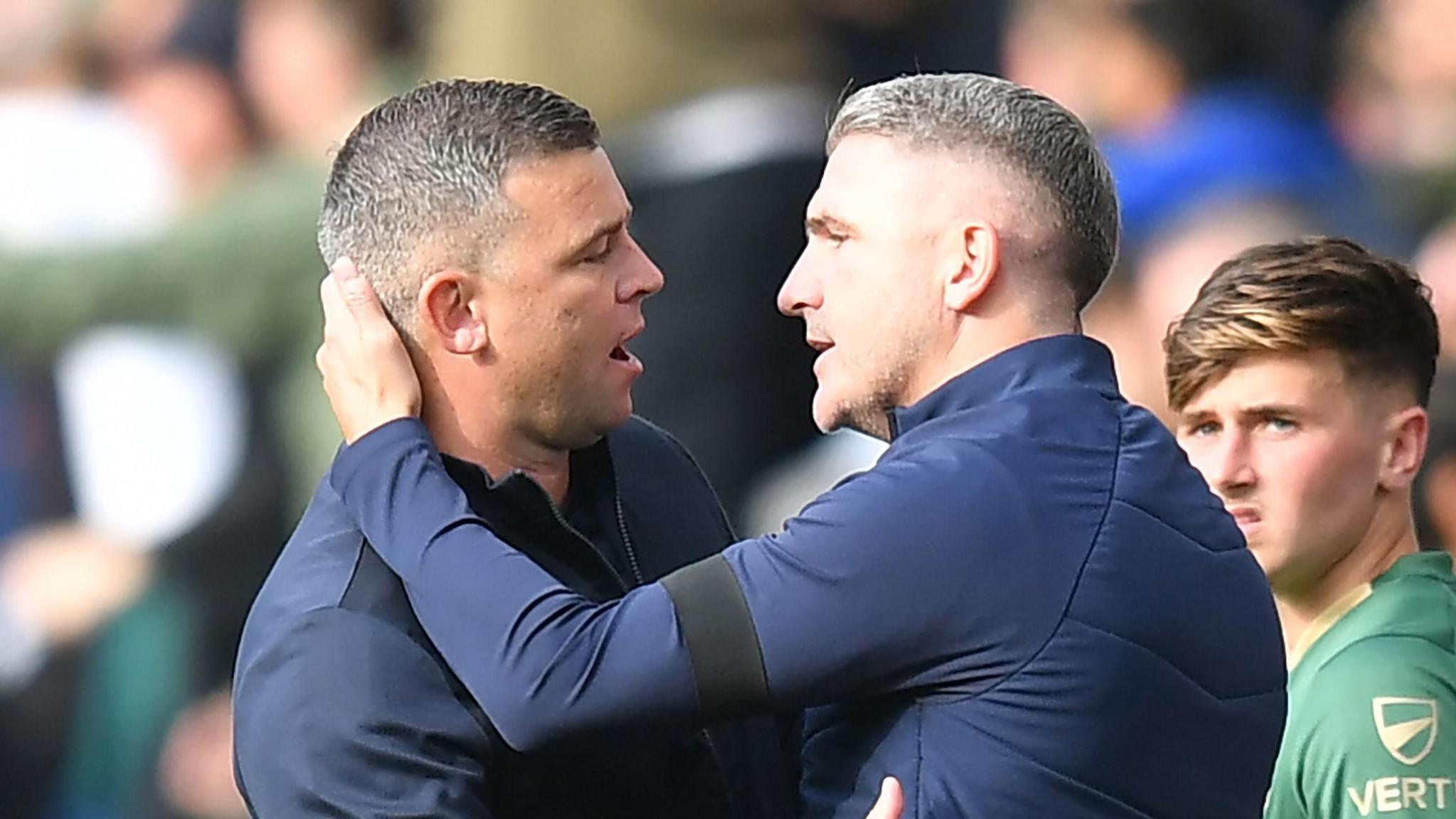 Steven Schumacher and Ryan Lowe embracing after a match between Preston North End and Plymouth Argyle