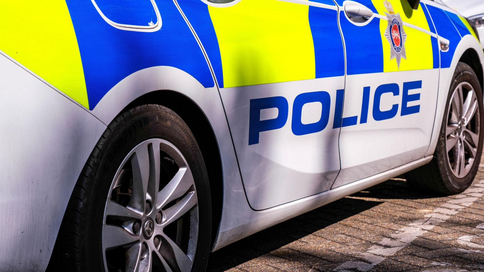 The side profile of a police vehicle.