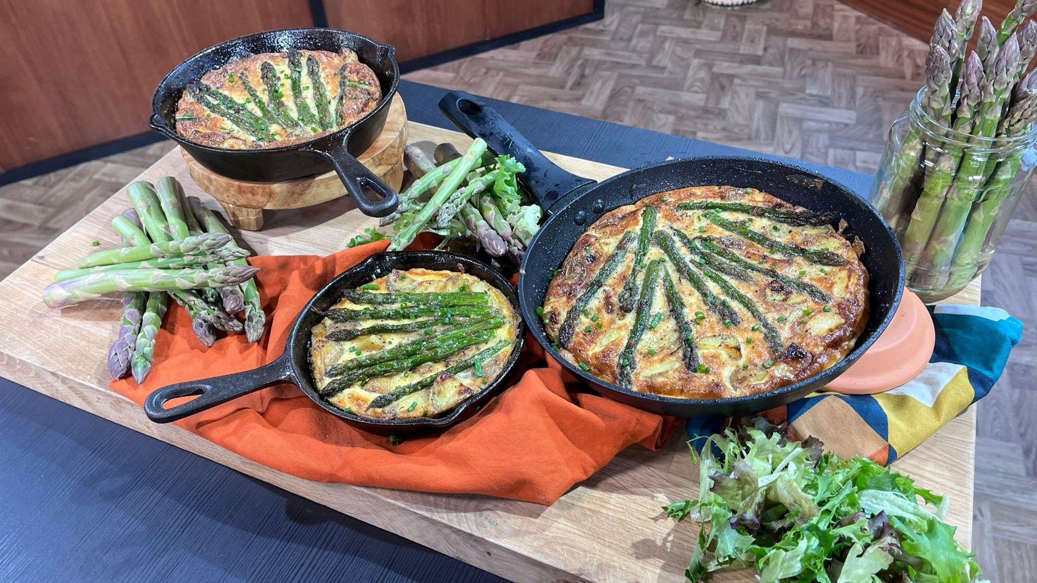 A photo of three asparagus frittatas on a chopping board
