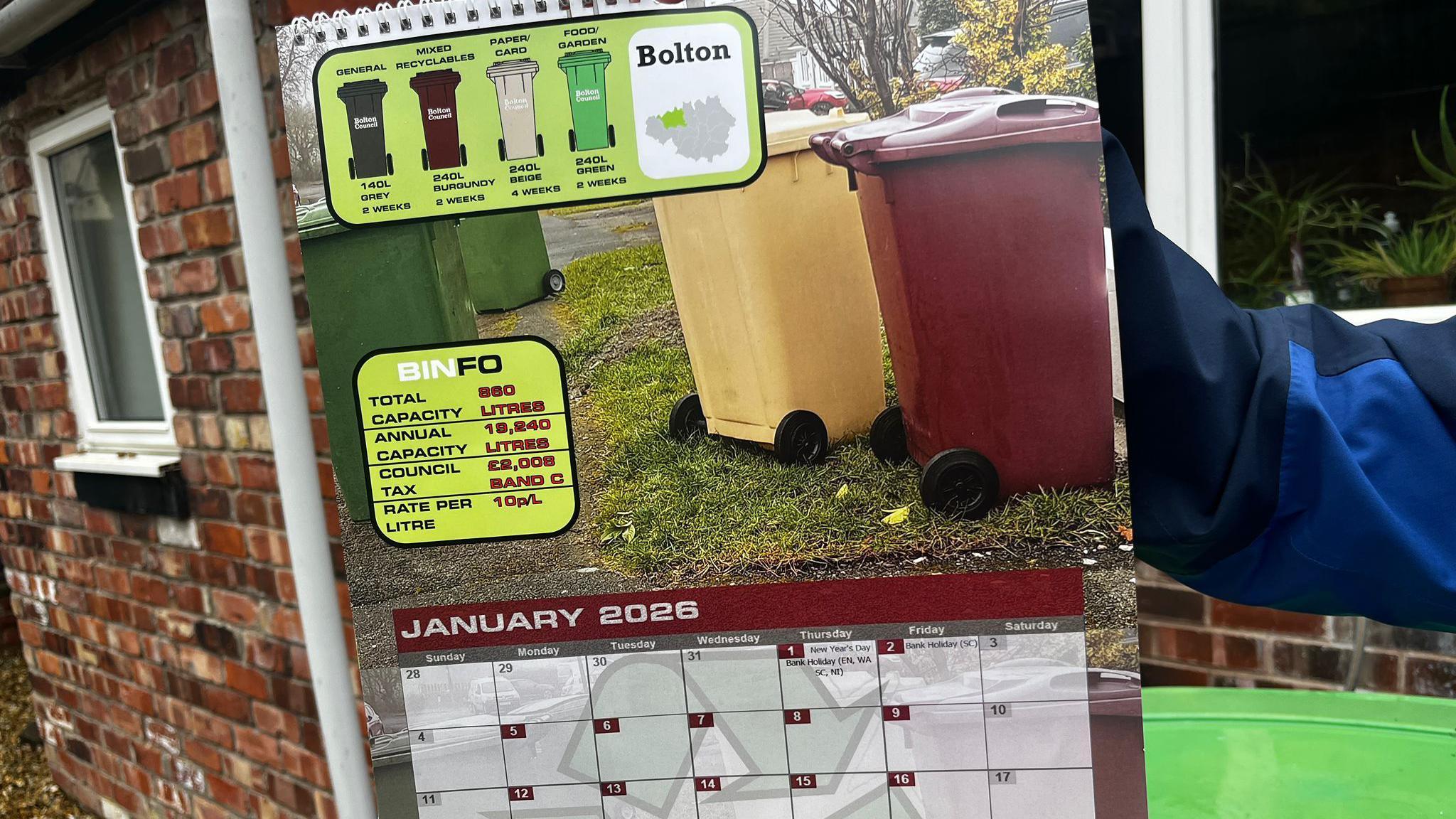 The calendar showing January 2026 with a photograph of Bolton's green, beige and burgundy bins