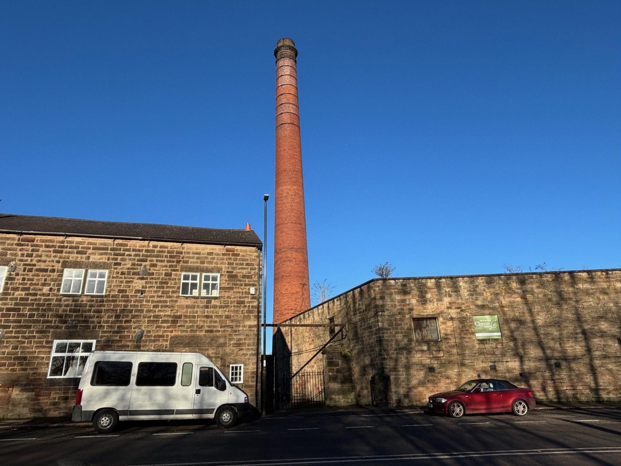 A view of the chimney against a brilliant blue sky