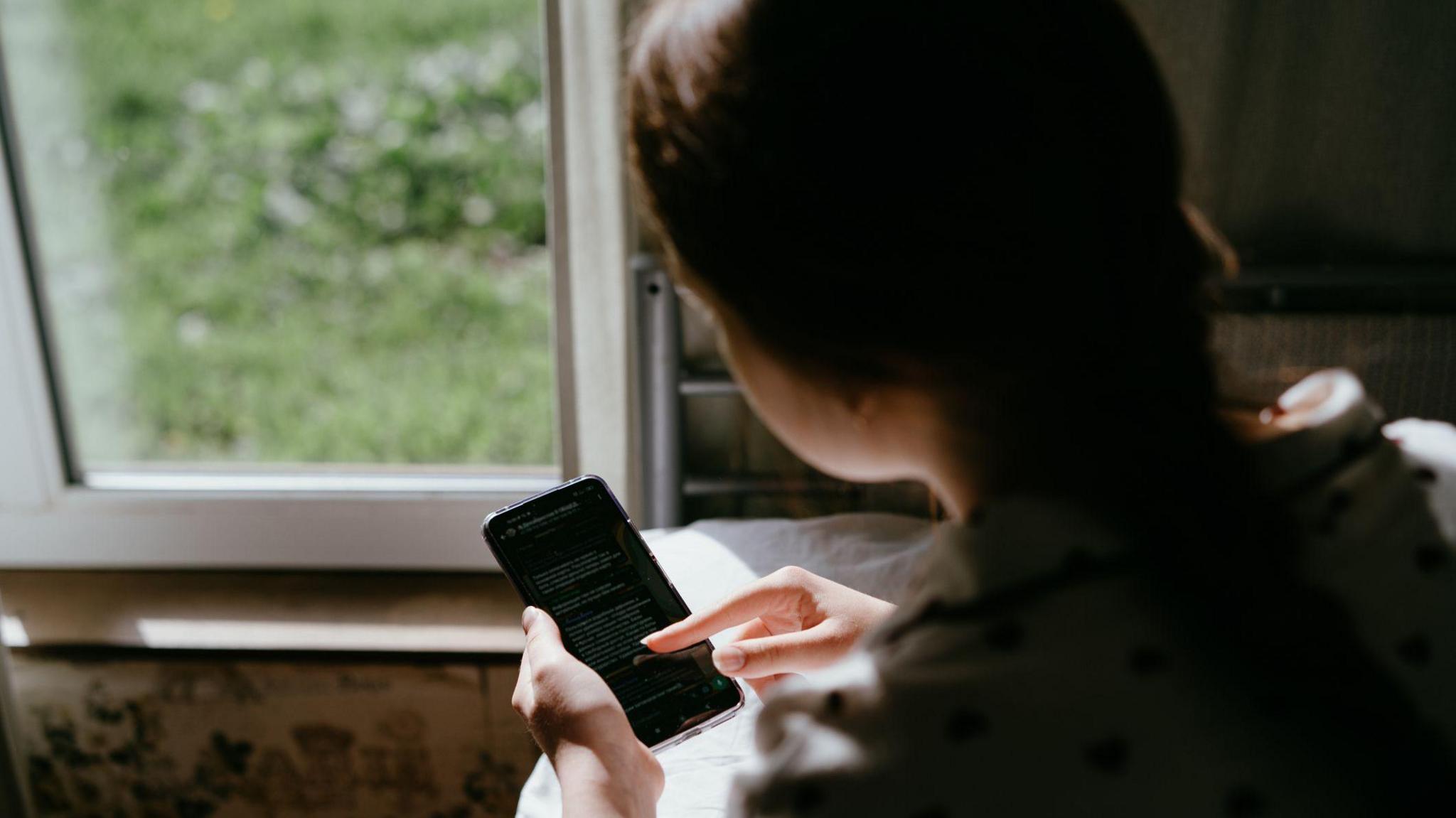 A young girl using a phone