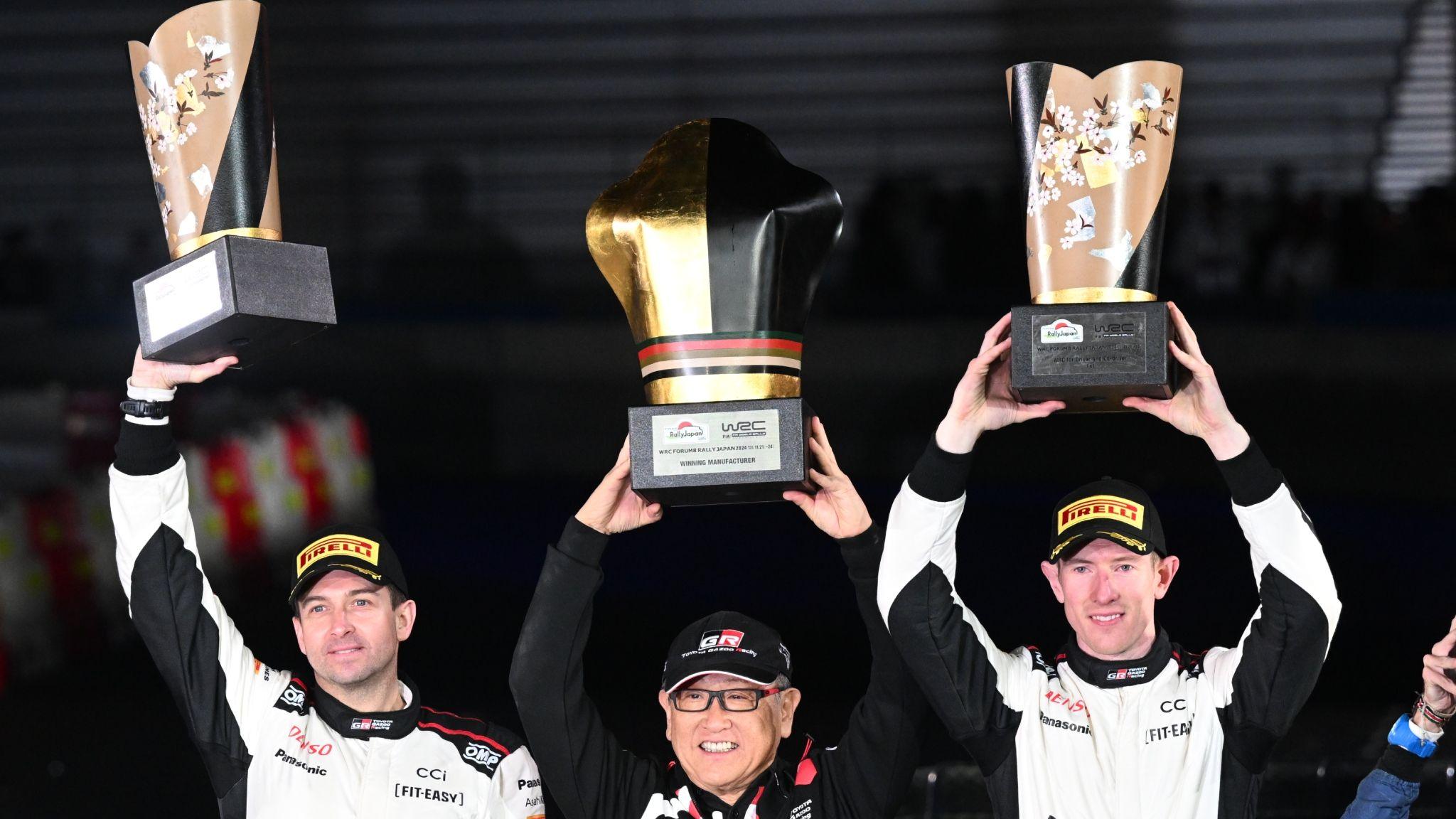 Elfyn Evans (right) and co-driver Scott Martin (left) celebrate their victory at Rally Japan 2024 with Toyota chief Akio Toyoda (centre)