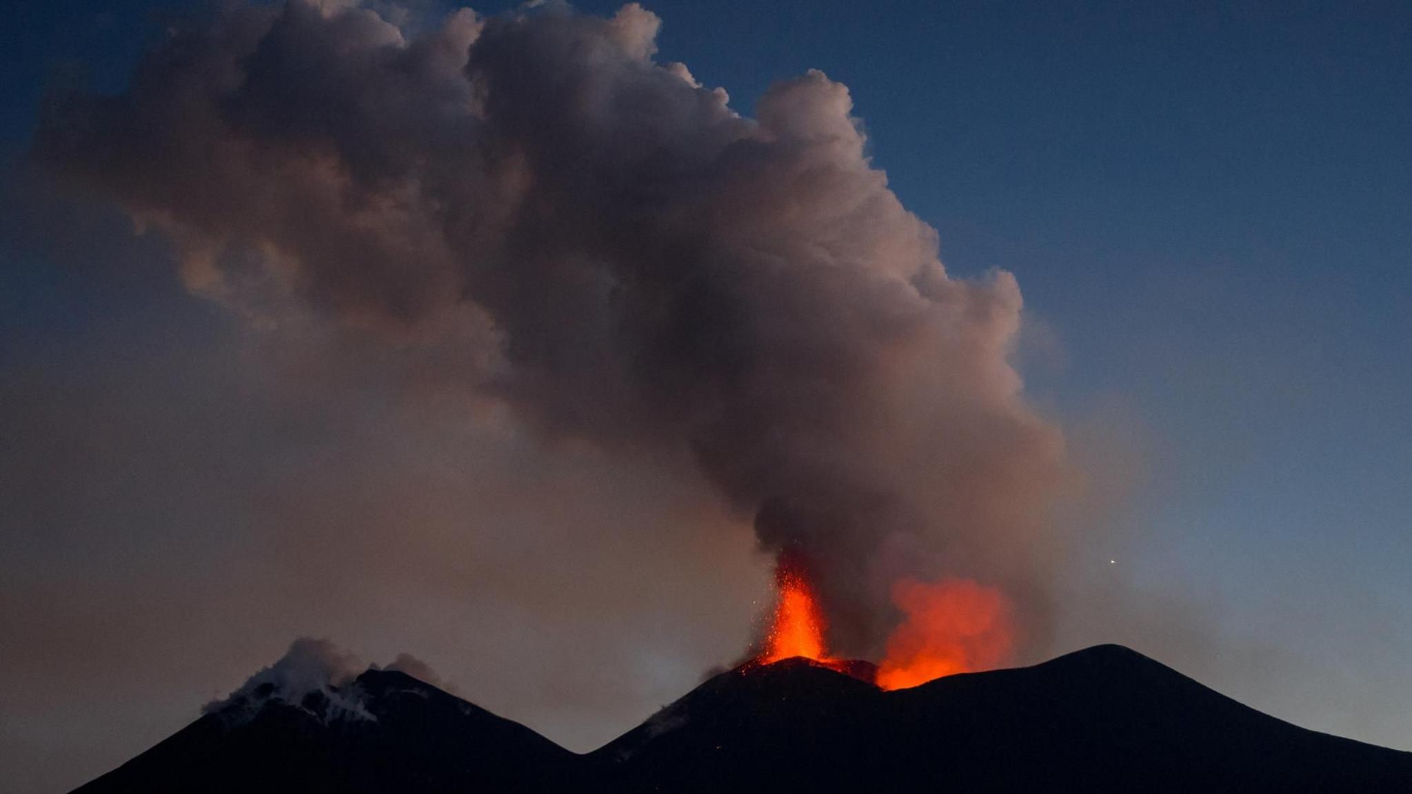 Drone footage shows lava being ejected from a crater during an eruption of Mount Etna at dusk, in Sicily, Italy, on 13 August 2026.
