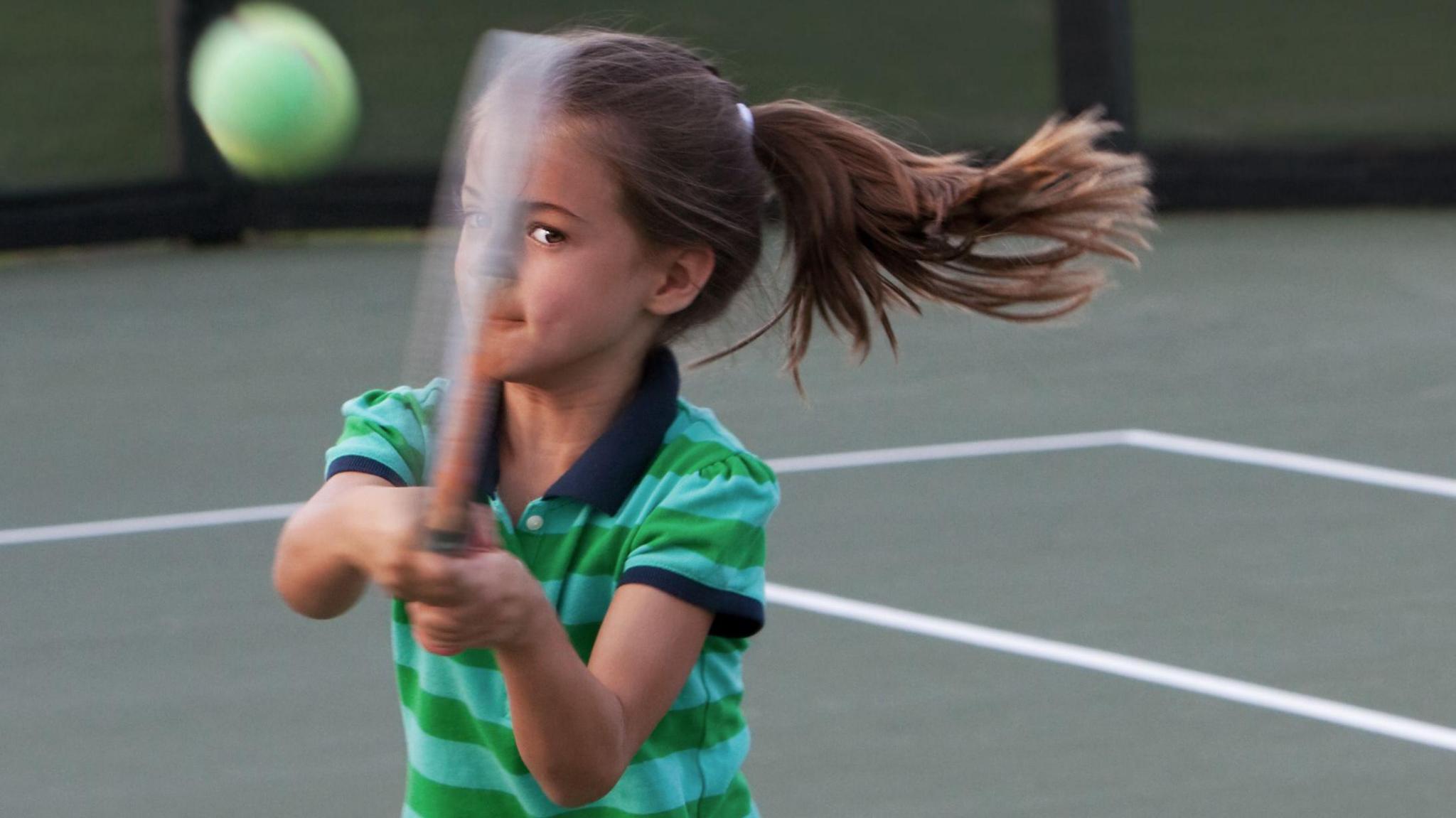 Child playing tennis