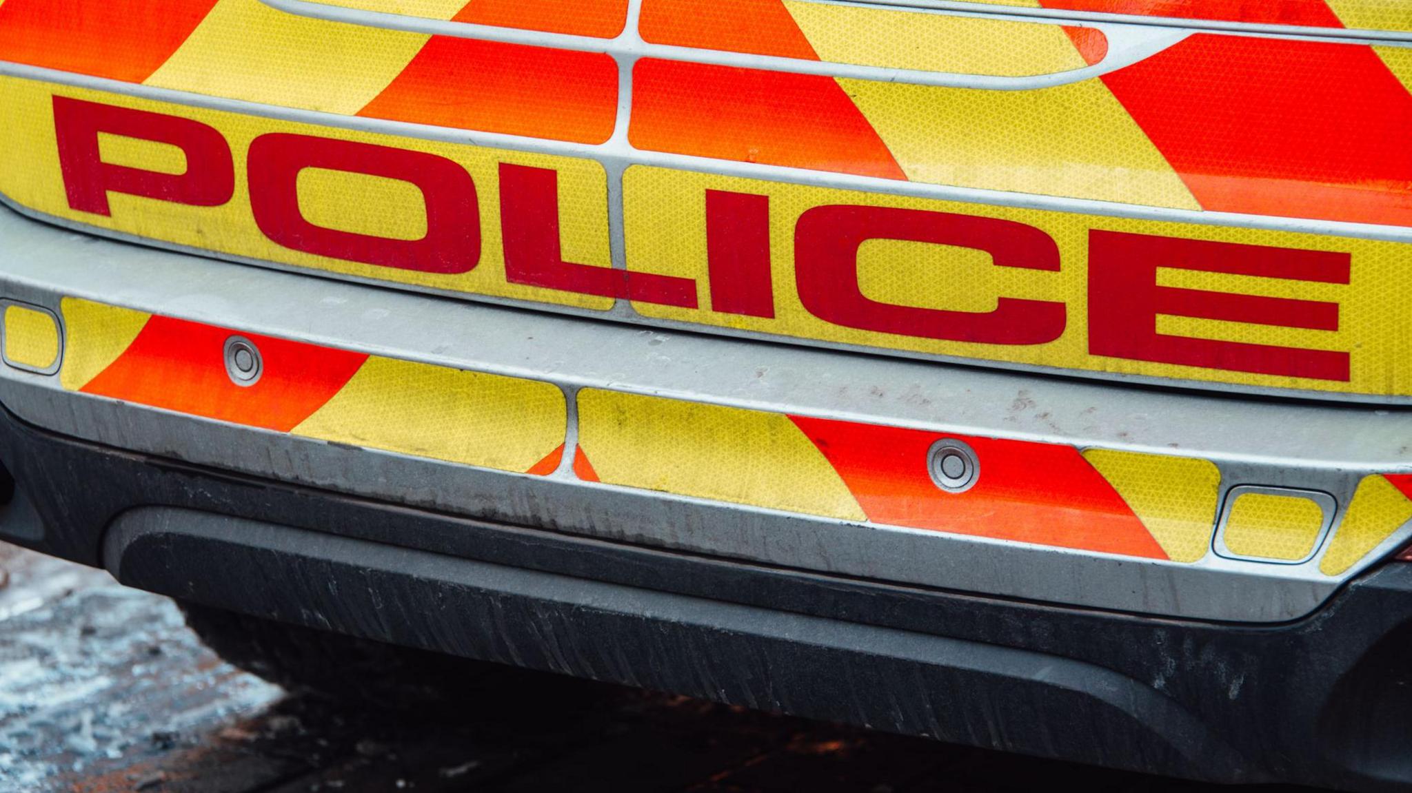 A general view of the back and bumper of a UK police car, with writing that says "POLICE"