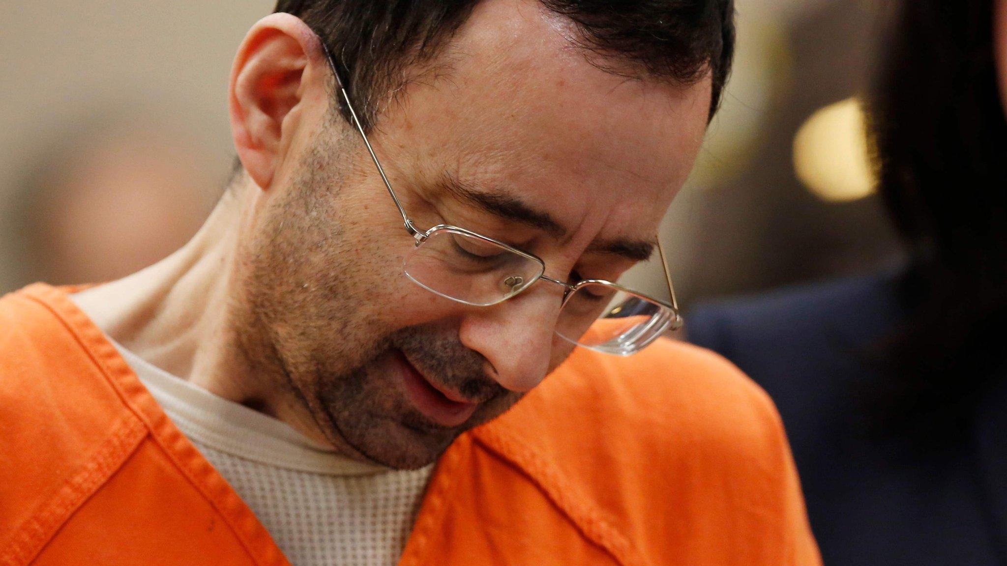 Former Michigan State University and USA Gymnastics doctor Larry Nassar reacts as hears charges he pled to in Ingham County Circuit Court in Lansing, Michigan, on 22 November 2017 (file image)