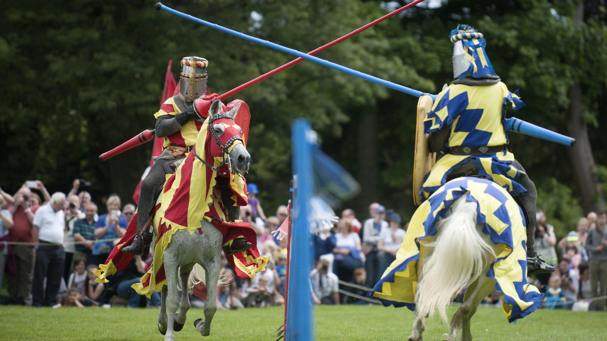 Two knights joust at a modern re-enactment show