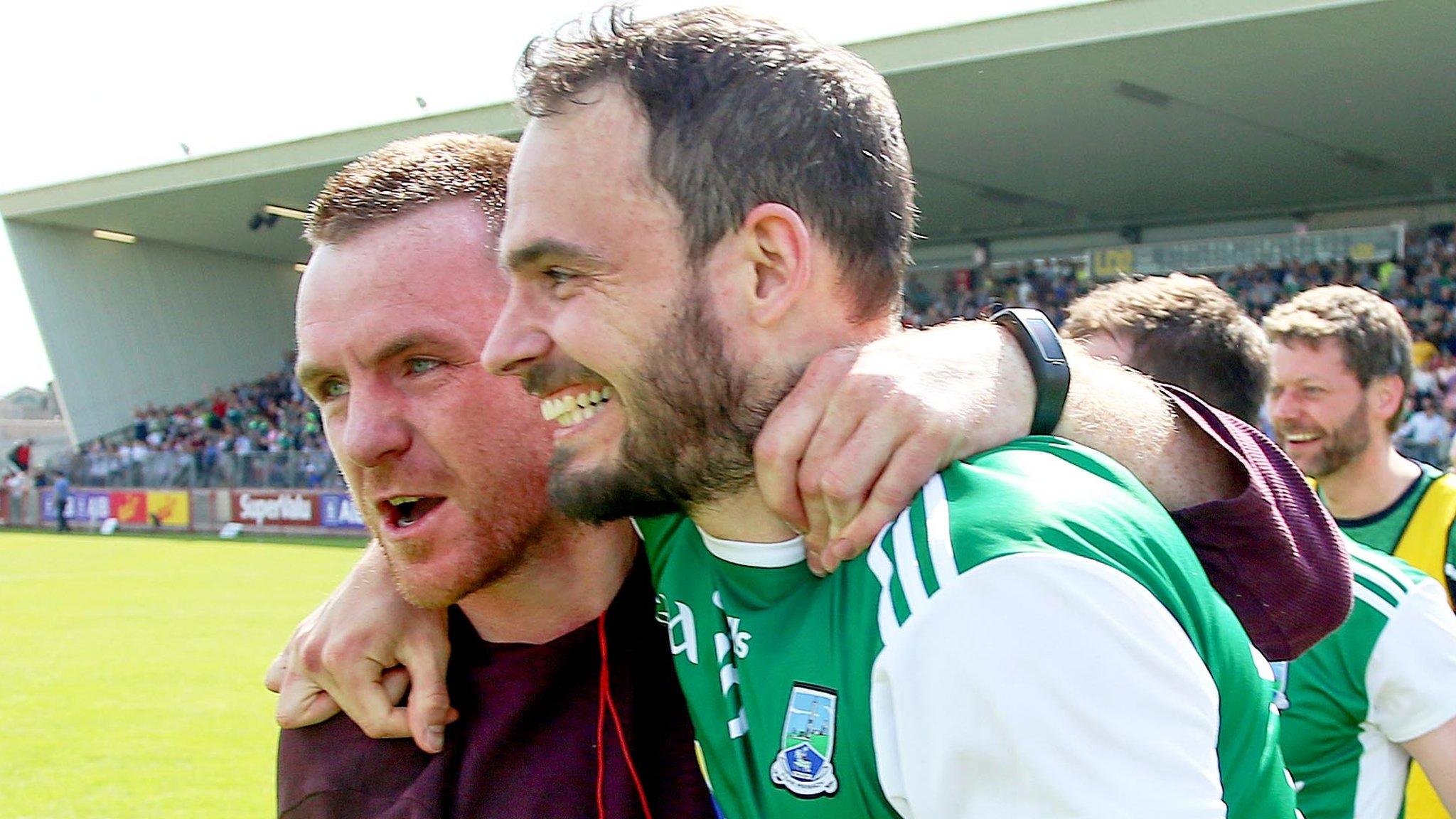 Paul McCusker celebrates with former Fermanagh player Martin McGrath after the Erne County's last-gasp win over Monaghan