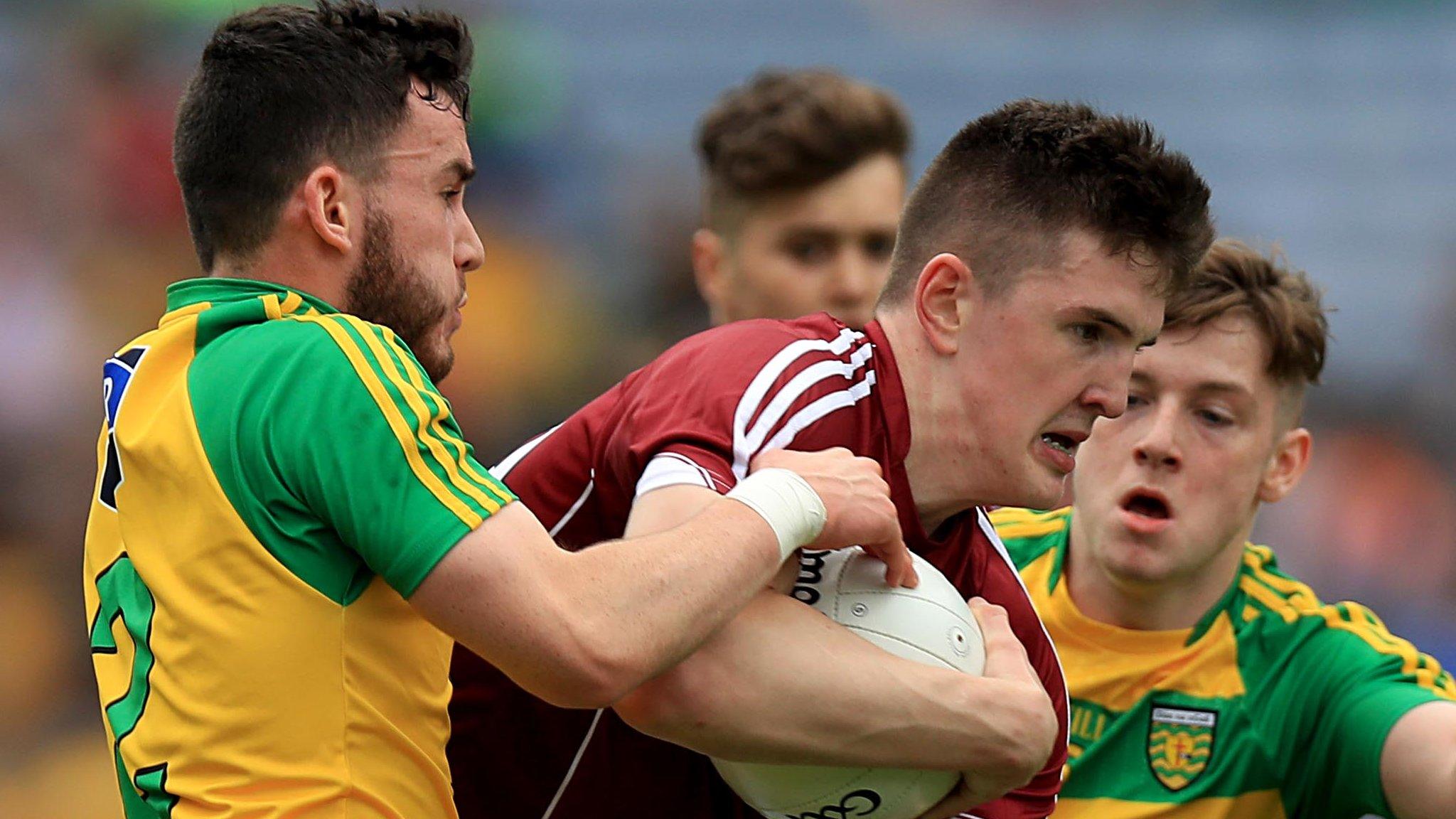 Donegal's Seaghan Ferry attempts to halt the run of Galway opponent Celn D'Arcy