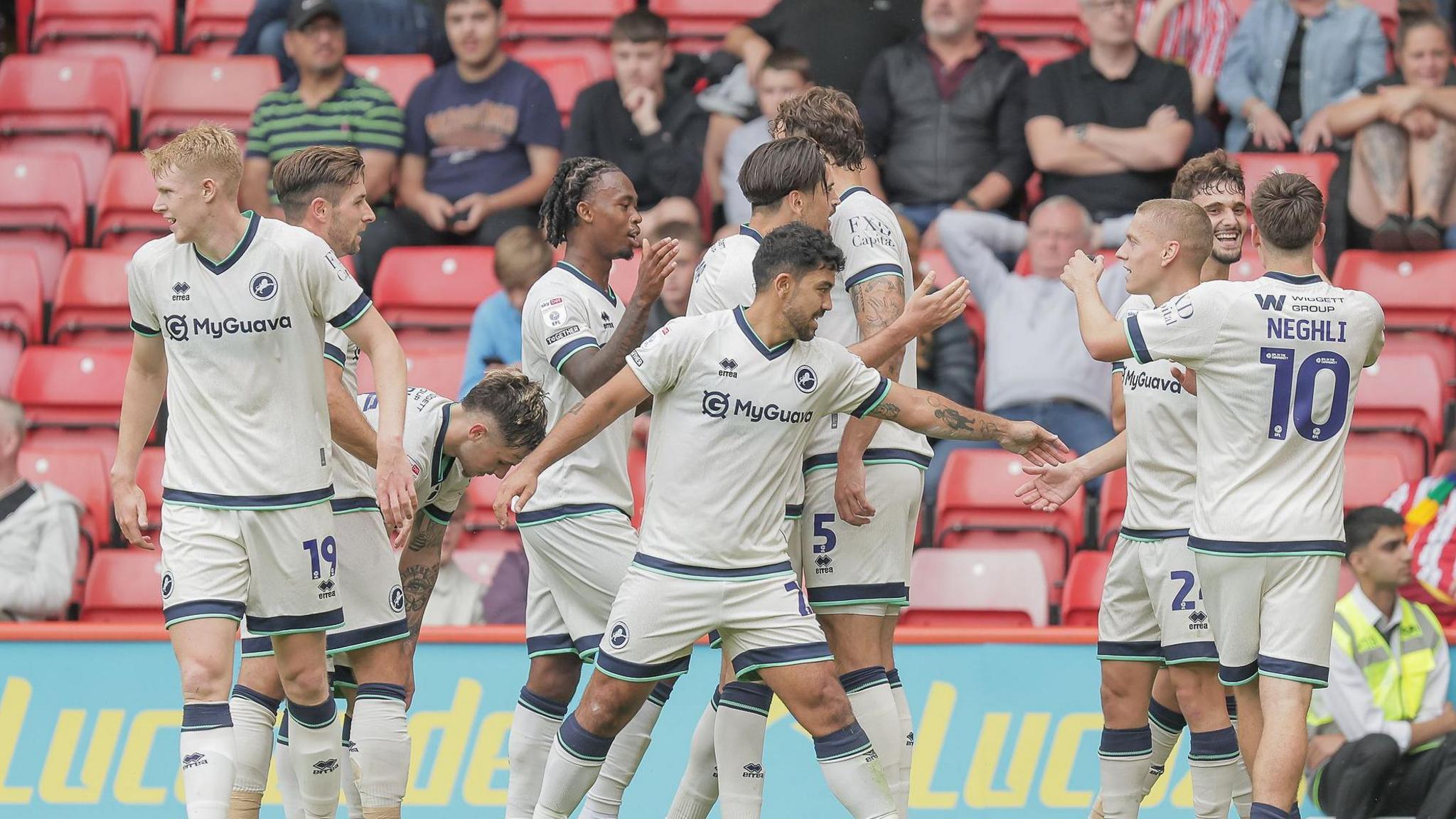 Millwall players celebrate with goalscorer Luke Cundle