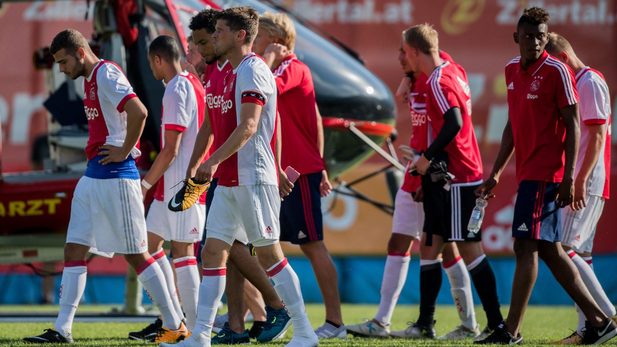 Ajax players react after Abdelhak Nouri collapses during a friendly against Werder Bremen