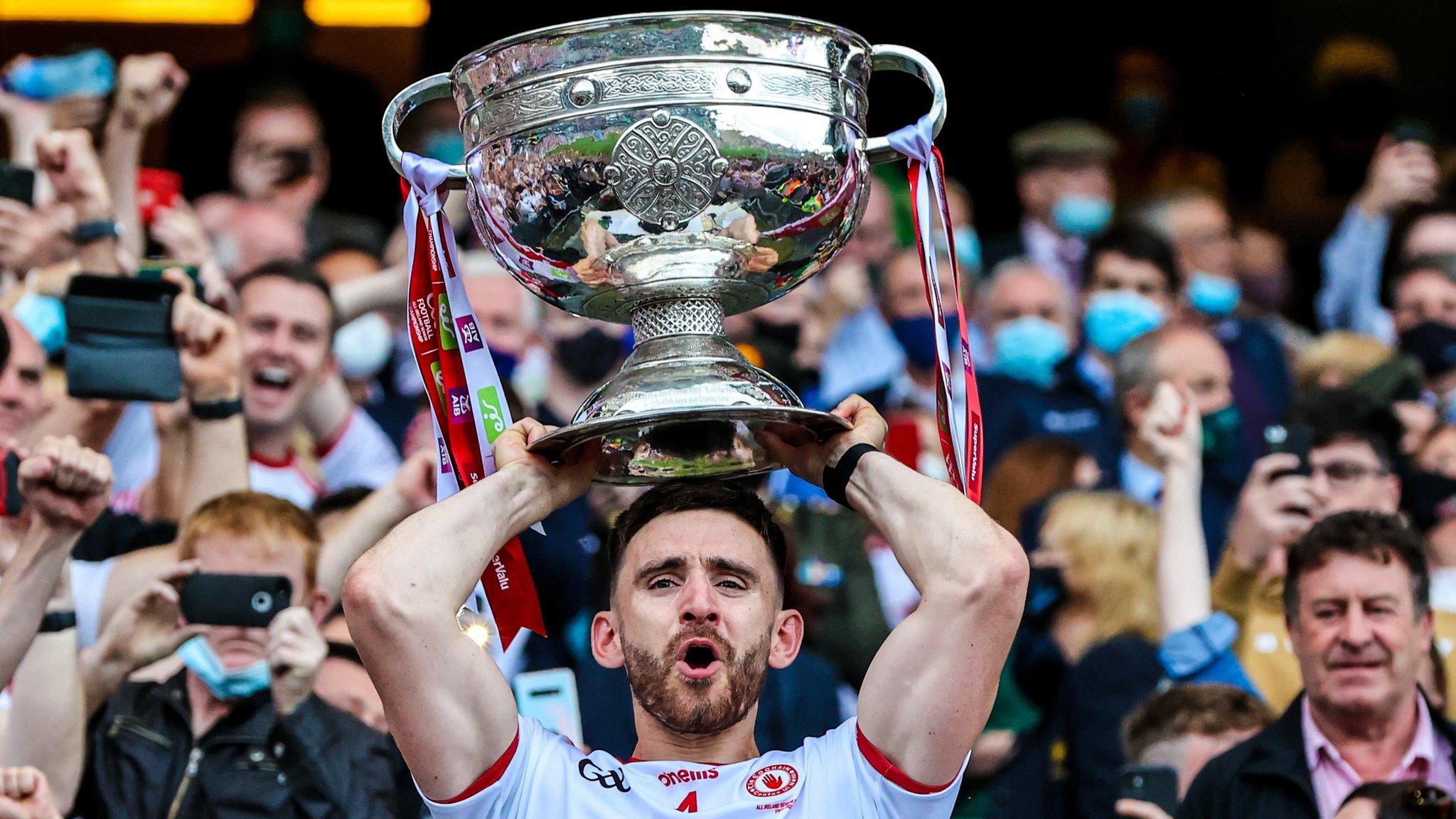 Tyrone captain Padraig Hampsey holds the Sam Maguire Cup aloft