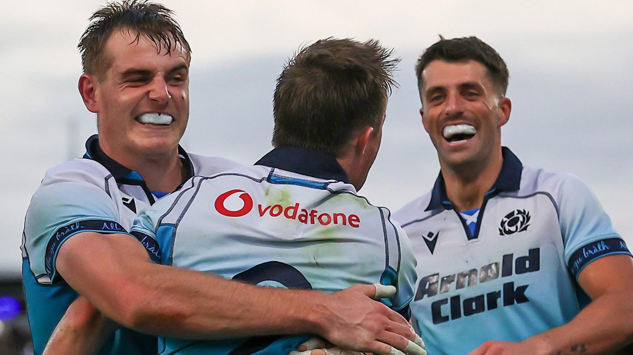 Stafford McDowell and Adam Hastings congratulate try-scorer George Horne