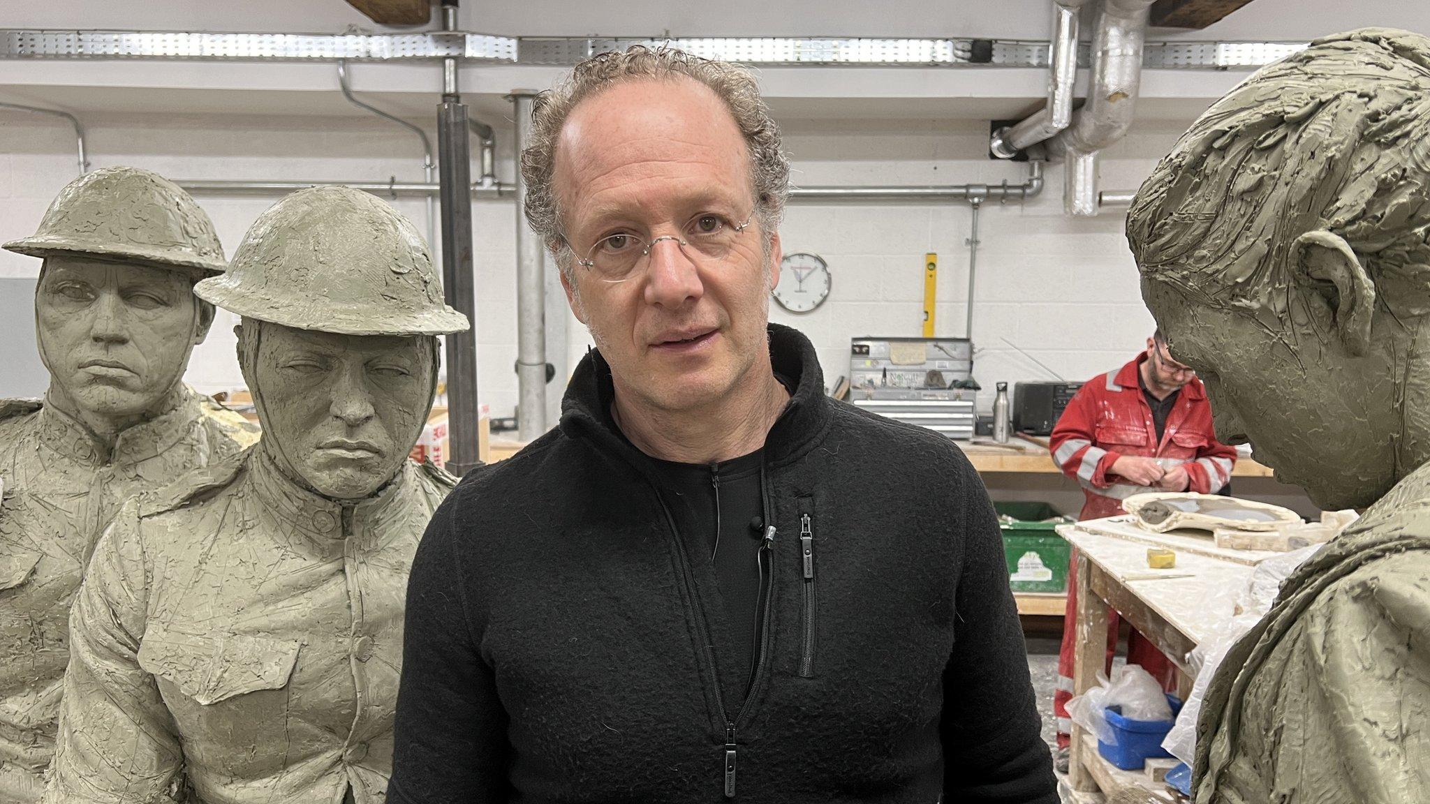 Sculptor Sabin Howard standing among his sculptures