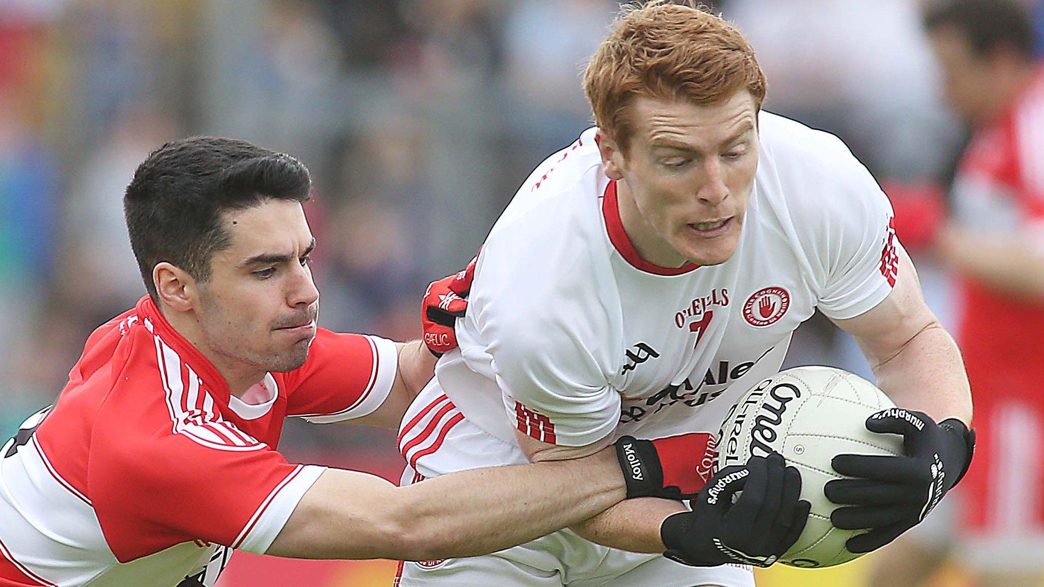 Derry defender Niall Kenan tackles Tyrone's Peter Harte