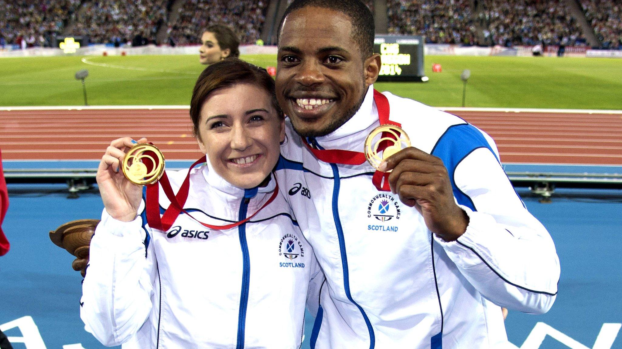 Libby Clegg and guide runner Mikail Huggins celebrate with their gold medals after winning the Women's Para-Sport 100m T12 at Glasgow 2014