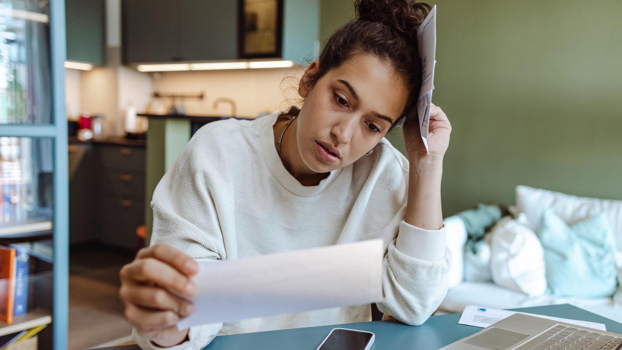 A woman looking at her water bill