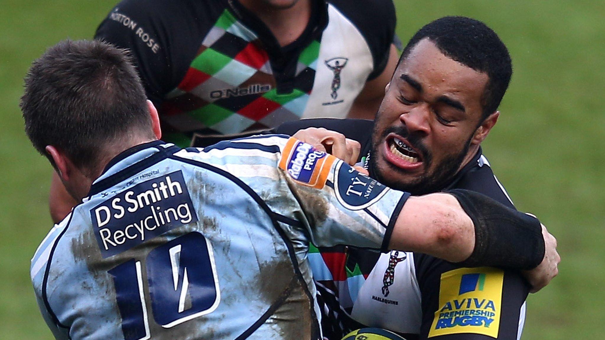 Darryl Marfo (right) is tackled by Ceri Sweeney