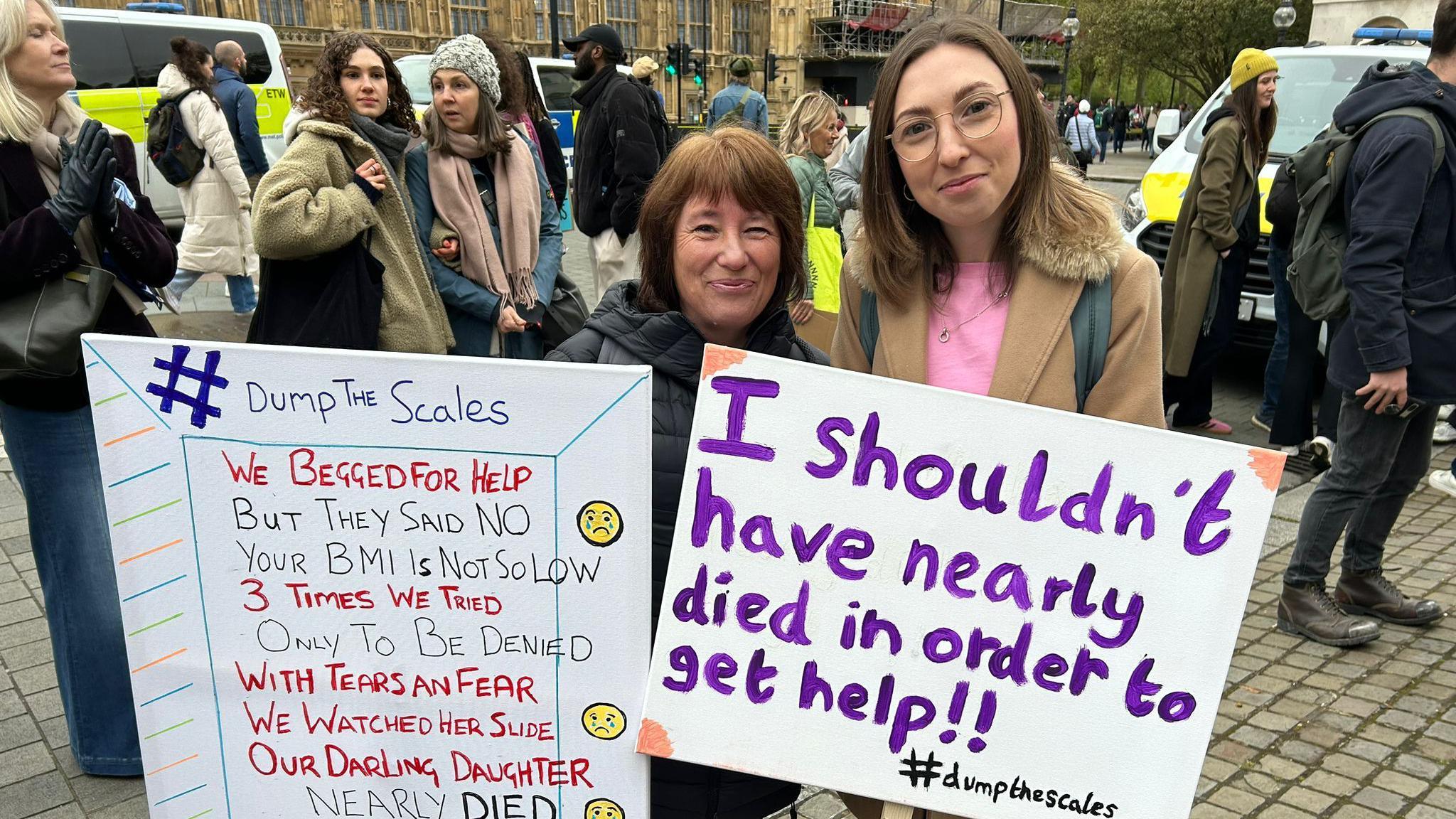 Rheanna Hazel with her mum at a march holding placards