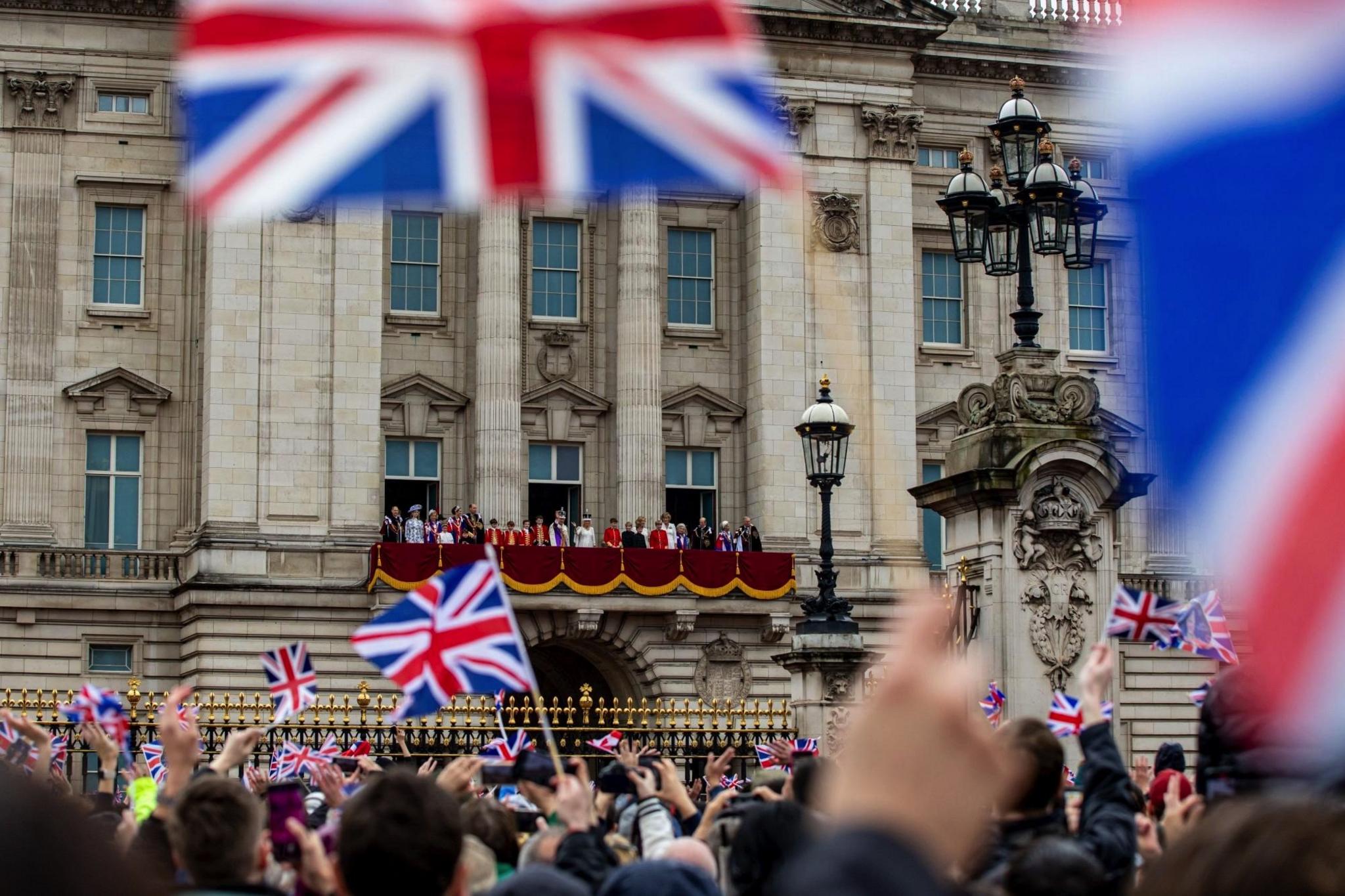 King Charles III and Queen Camilla with members of the royal family stand on the balcony of Buckingham Palace following their Coronation