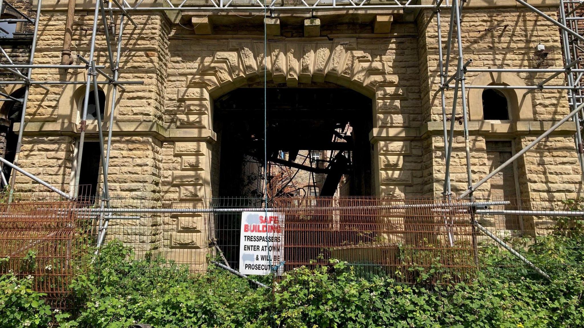 A fenced-off stone archway in one of the mill buildings 