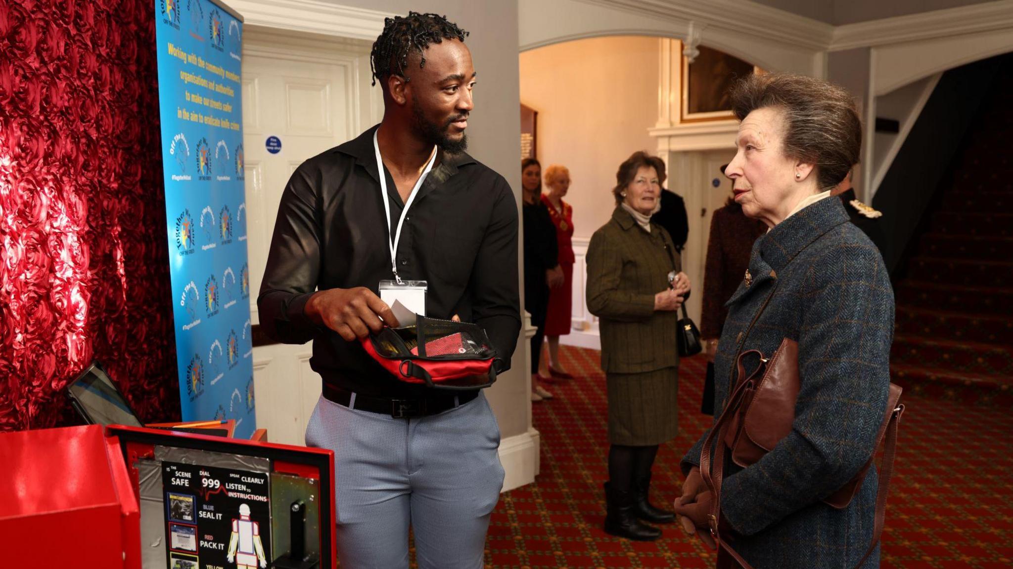 Rauvan Jones shows the Princess Royal an emergency bleed control kit