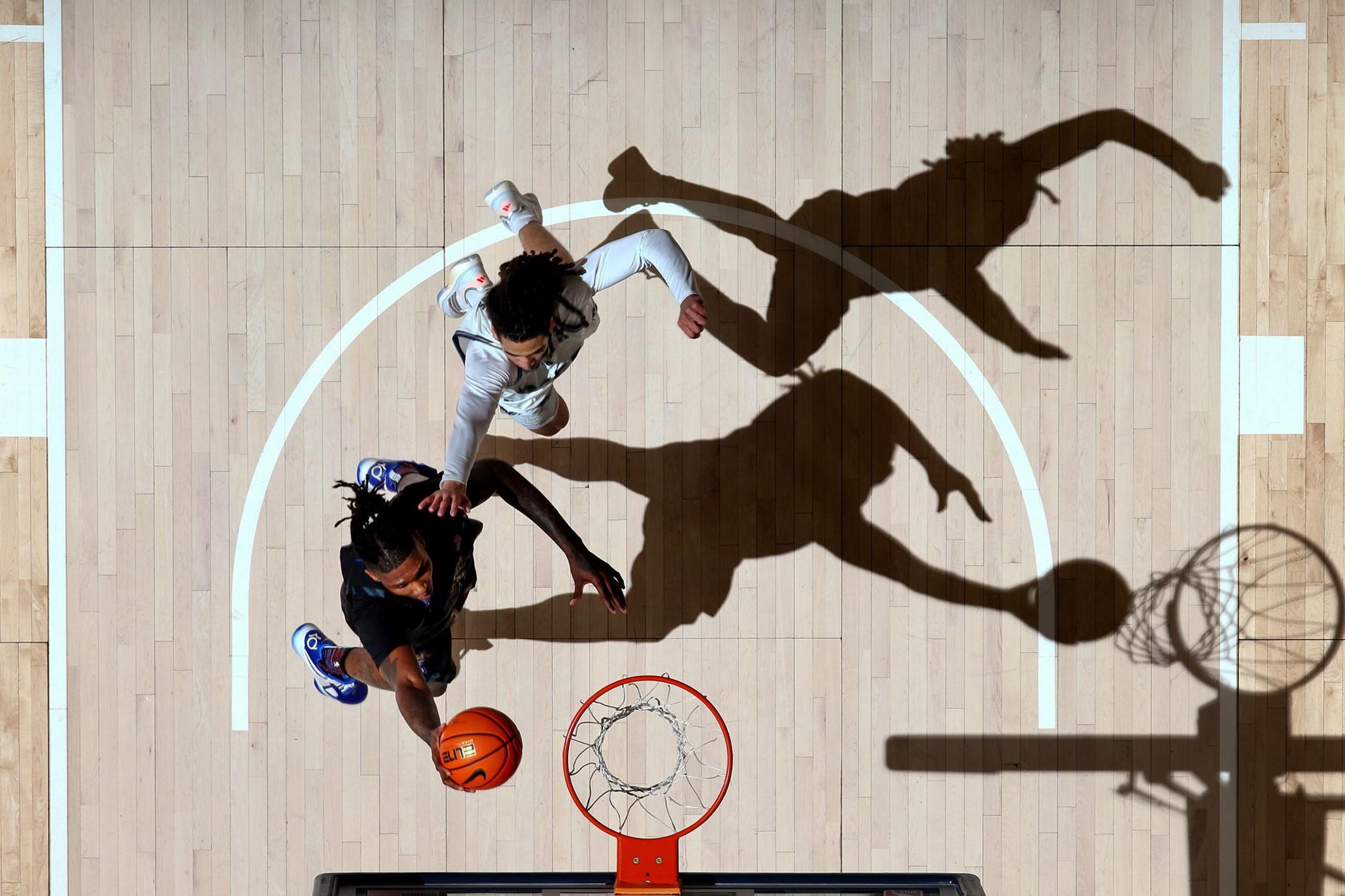 Memphis Tigers Dain Dainja drives to the basket for a layup against Rice Owls Kellen Amos during the second half at FedExForum in Memphis, Tennessee