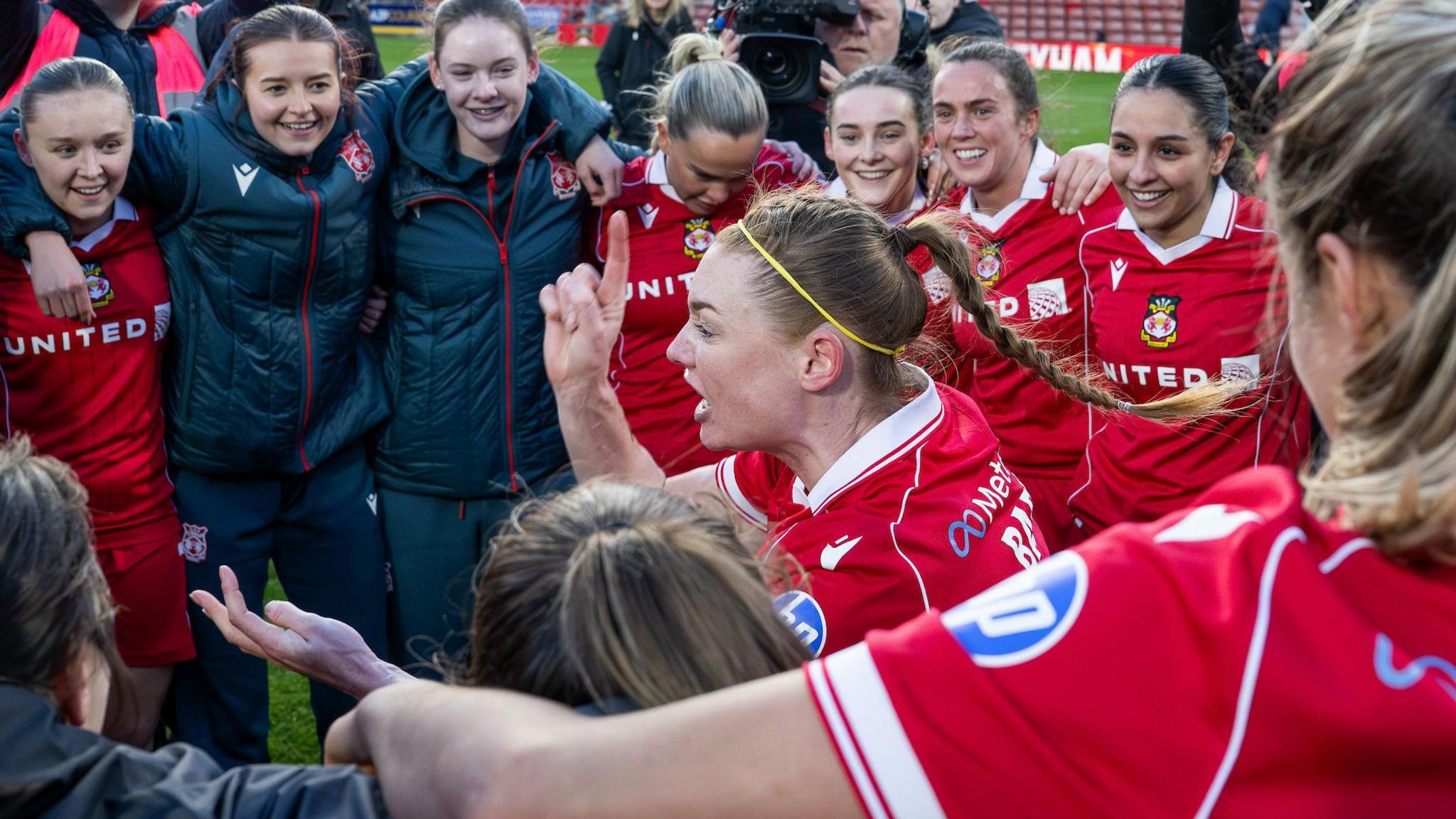 Wrexham captain Jodie Bartle leads a post-match huddle after their win over Cardiff City
