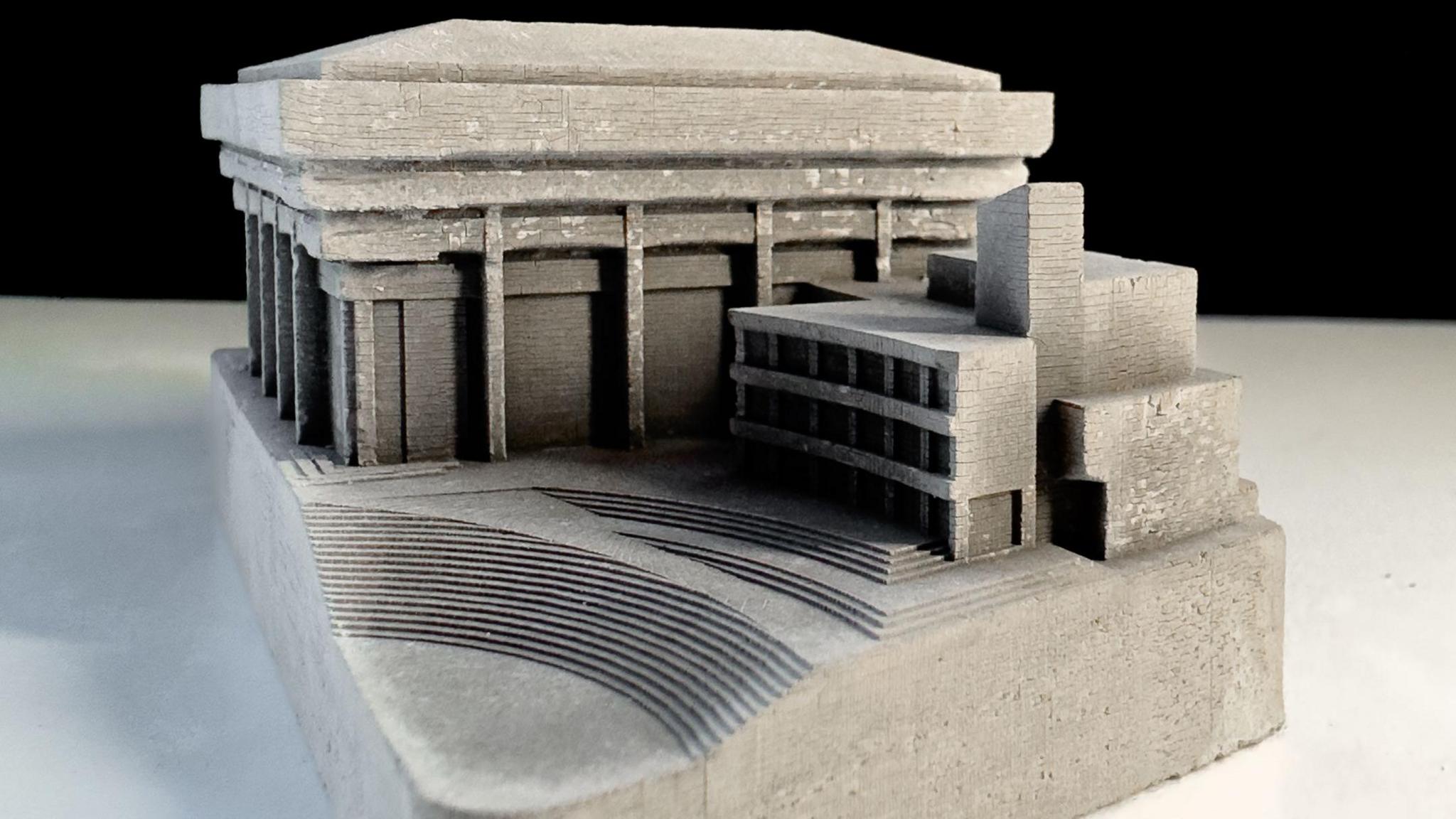 A concrete model of Birmingham Central Library which has steps leading up to the building and tiered roofing