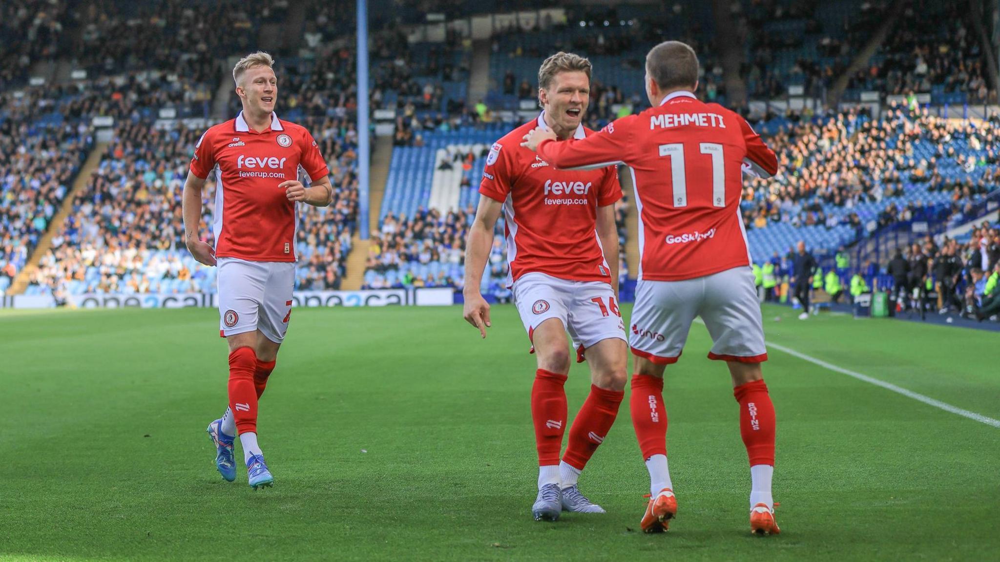 Bristol City's Ross McCrorie and Rob Dickie celebrate with Anis Mehmeti at Sheffield Wednesday